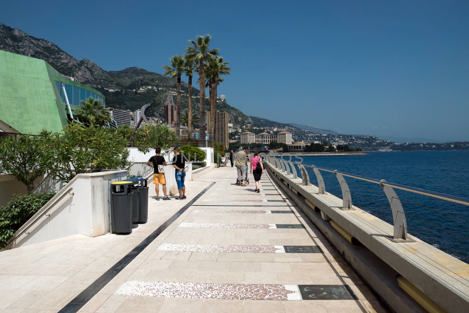 MONTE CARLO, MONACO - MAY 1: Larvotto Promenade on May 1, 2013 in Monte Carlo, Monaco. Larvotto is a part of the district of Monte Carlo in the Principality of Monaco.

Monte Carlo, Monaco - May 1, 2013: Larvotto Promenade. Larvotto is a part of the district of Monte Carlo in the Principality of Monaco. People walk along the waterfront.