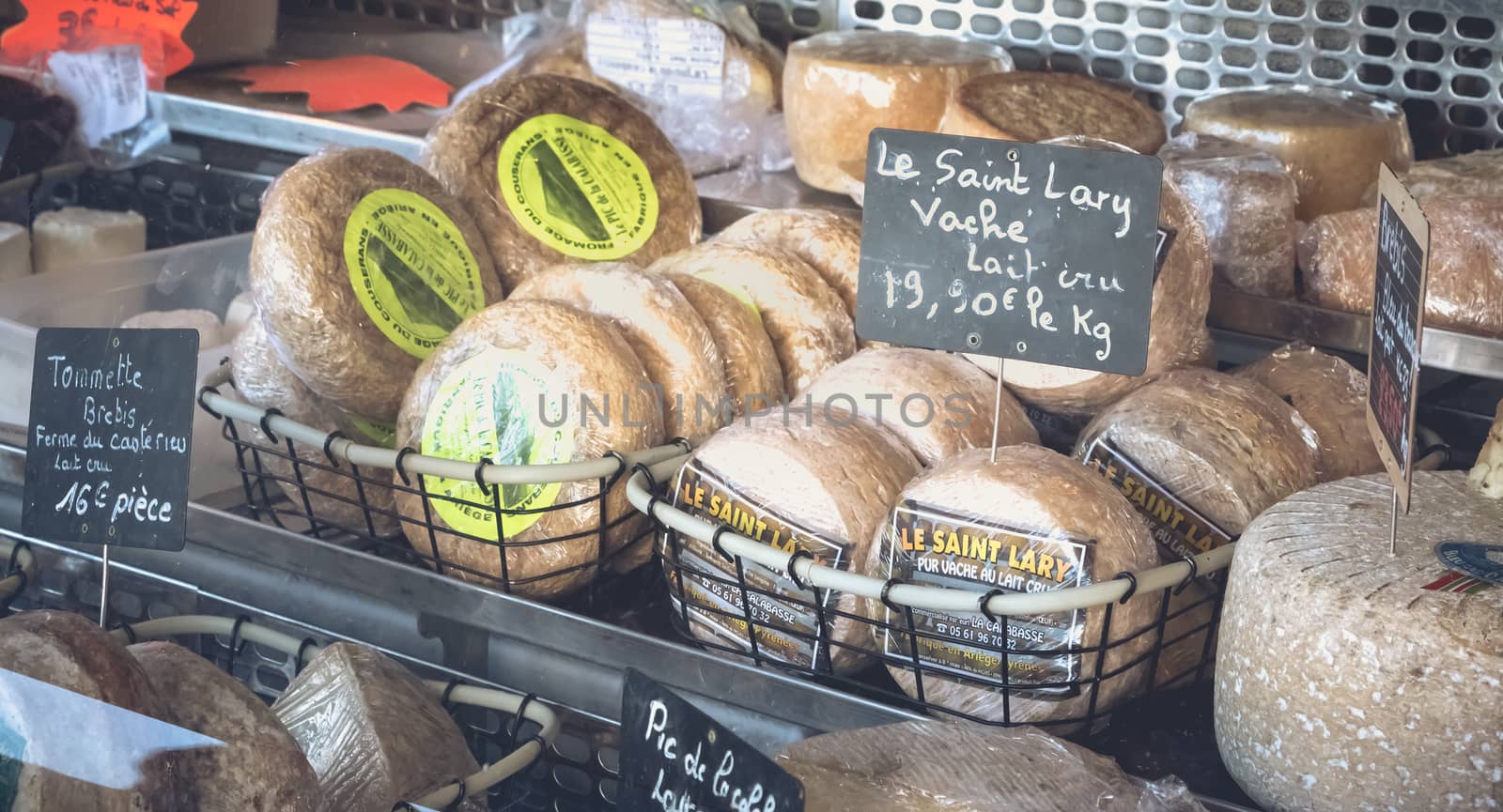 Saint Lary Soulan, France - August 20, 2018 : Showcase of a small cheese merchant on a mountain market on a summer day