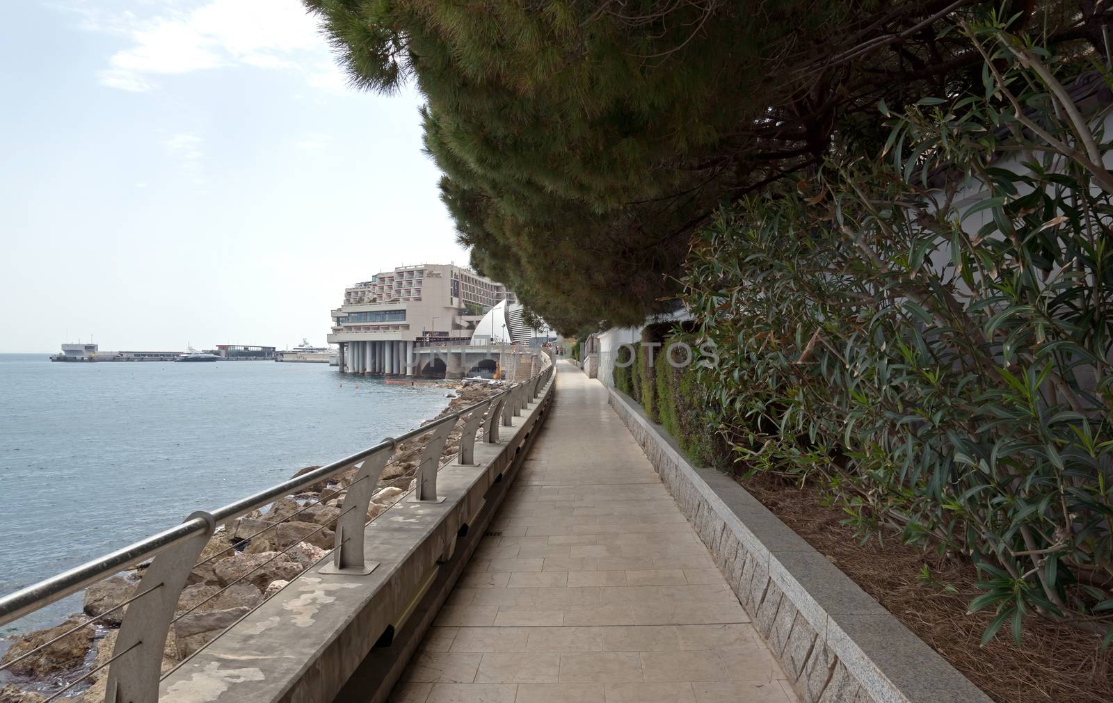 MONTE CARLO, MONACO - MAY 1: Larvotto Promenade on May 1, 2013 in Monte Carlo, Monaco. Larvotto is a part of the district of Monte Carlo in the Principality of Monaco.

Monte Carlo, Monaco - May 1, 2013: Larvotto Promenade. Larvotto is a part of the district of Monte Carlo in the Principality of Monaco. People walk along the waterfront.