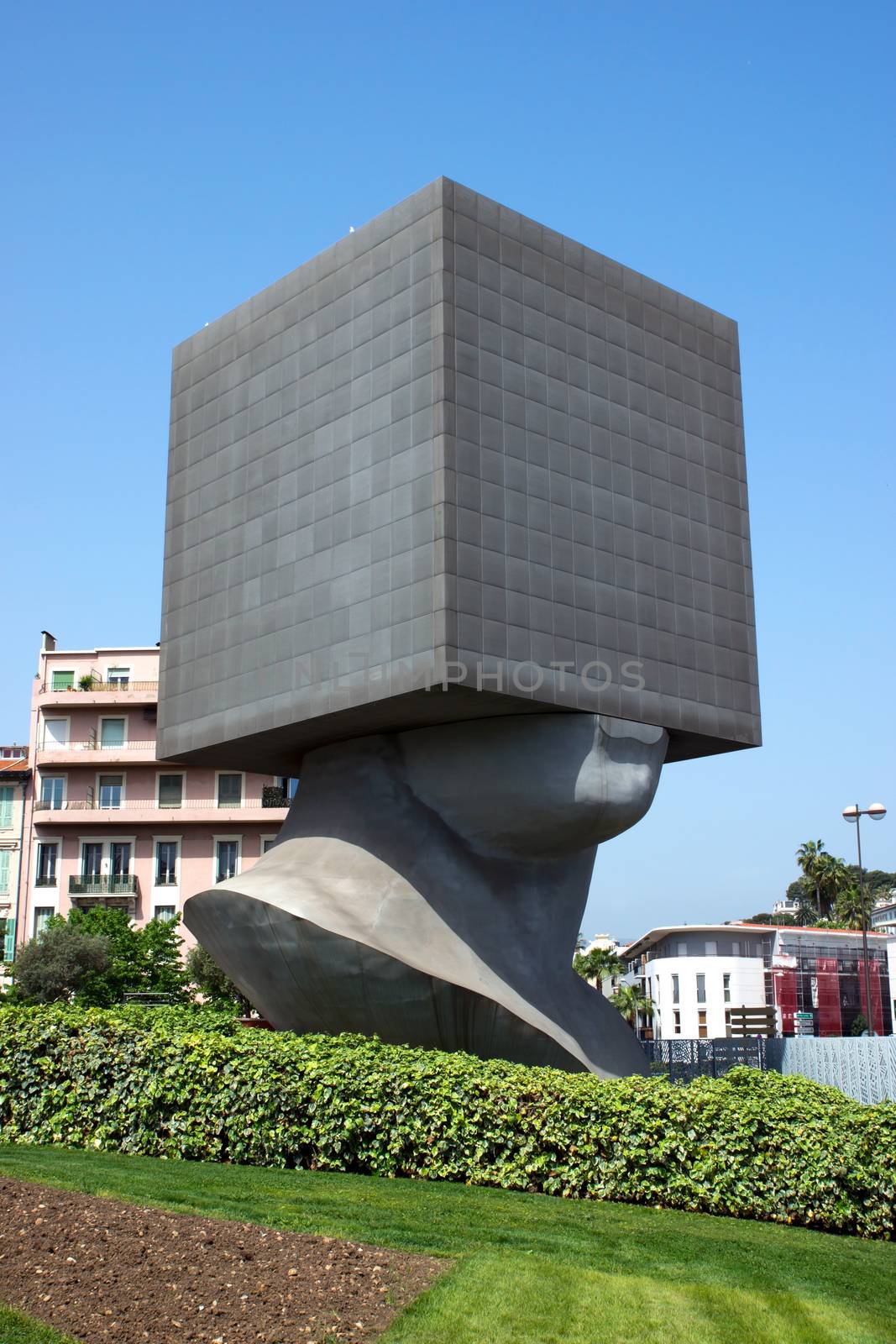 Seven storied building cube shaped as human head. It is the first monumental habitable sculpture in the world.

NICE, FRANCE - MAY 2: Square Head - building cube shaped as human head sculpture on May 2, 2013 in Nice, France. Authors are sculptor Sacha Sosno and architect Yves Bayard. Opened on June 29, 2002.

For Dreamstime:
Nice, France - December 06, 2005: Square Head - a seven storied building cube shaped as human head sculpture in Nice, France. Authors are sculptor Sacha Sosno and architect Yves Bayard. Opened on June 29, 2002, now Square Head houses the library administration.