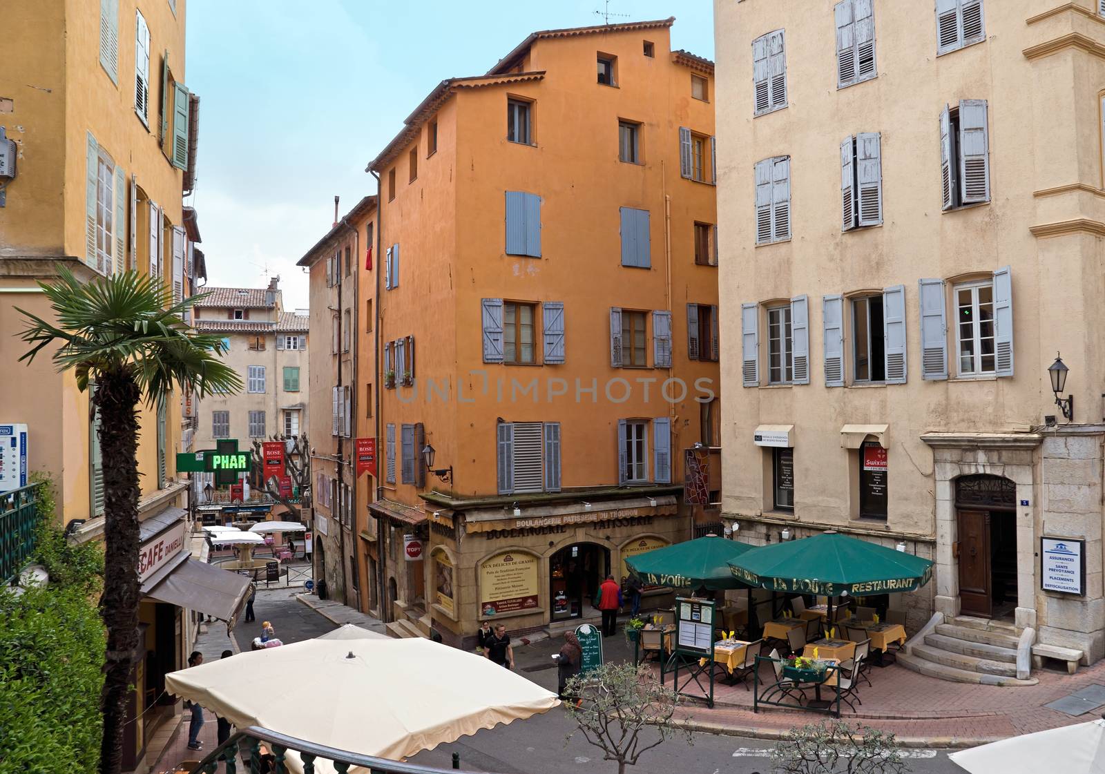 GRASSE, FRANCE - MAY 3: Architecture of Grasse Town in the southern France on May 3, 2013 in Grasse, France. Grasse is famous for its perfume industry. The city was founded in the XI century.

Grasse, France - May 3, 2013: Architecture of Grasse Town in the southern France. It is a city in the French department of Alpes-Maritimes. Grasse is famous for its perfume industry. The city was founded in the XI century. People stand on the street.