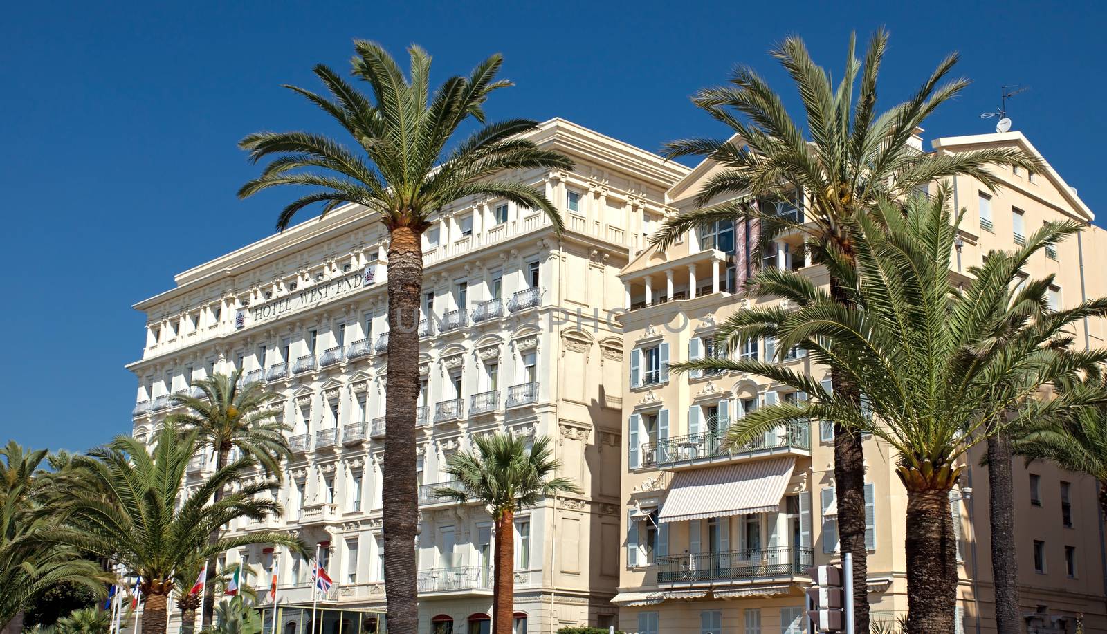 NICE, FRANCE - MAY 4: Architecture along Promenade des Anglais on May, 4, 2013 in Nice, France. It is a symbol of the Cote d'Azur and was built in 1830 at the expense of the British colony.

Nice, France - May 4, 2013: Architecture along Promenade des Anglais. People are walking. Promenade des Anglais is a symbol of the Cote d'Azur and was built in 1830 at the expense of the British colony.