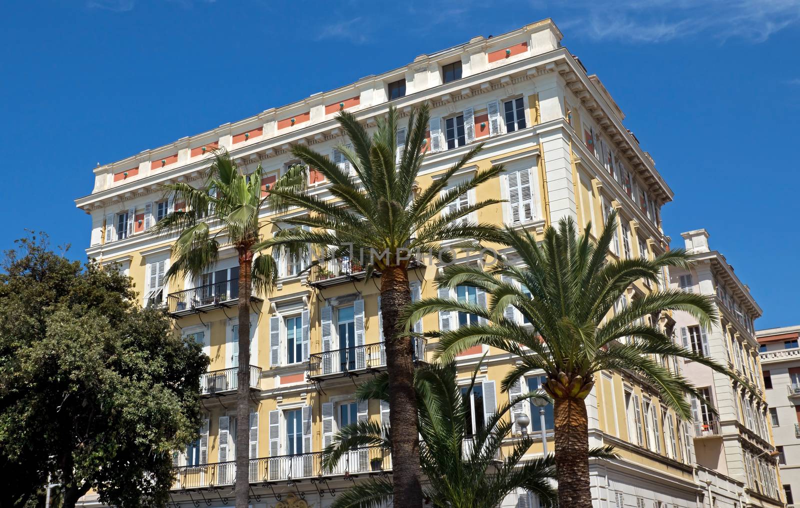 NICE, FRANCE - MAY 4: Architecture along Promenade des Anglais on May, 4, 2013 in Nice, France. It is a symbol of the Cote d'Azur and was built in 1830 at the expense of the British colony.

Nice, France - May 4, 2013: Architecture along Promenade des Anglais. People are walking. Promenade des Anglais is a symbol of the Cote d'Azur and was built in 1830 at the expense of the British colony.