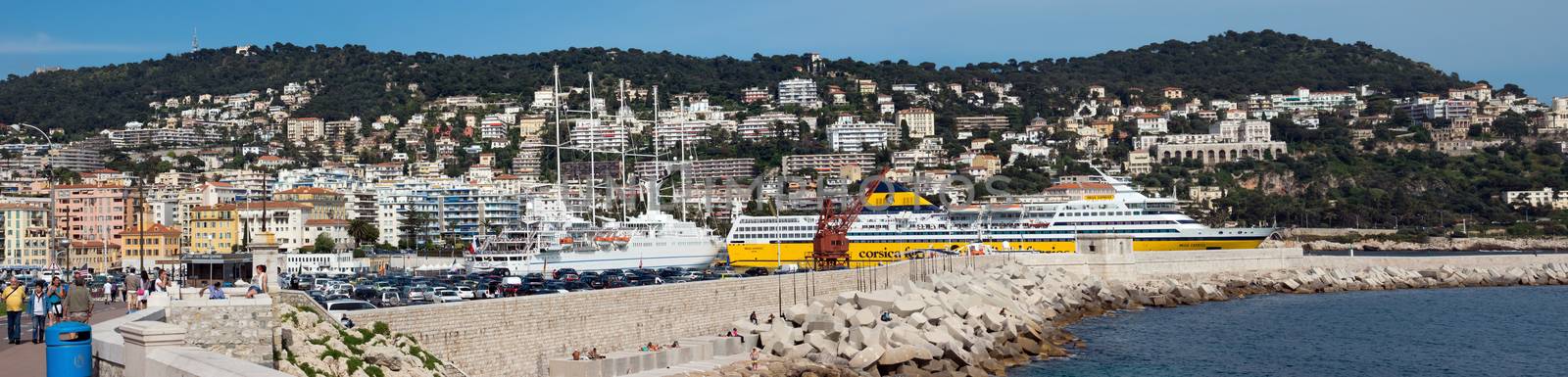 NICE, FRANCE - MAY 4: Panoramic view of Port de Nice on May 4, 2013 in Nice, France. Port de Nice was started in 1745.

Nice, France - May 4, 2013: Panoramic view of Port de Nice in French Riviera. Port de Nice was started in 1745. People are walking along Promenade.
