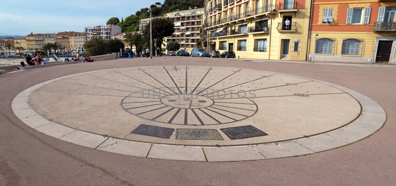 NICE, FRANCE - MAY 4: Sundial on Promenade des Anglais on May 4, 2013 in Nice, France. It is a symbol of the Cote d'Azur and was built in 1830 at the expense of the British colony.

Nice, France - May 4, 2013: Sundial on Promenade des Anglais. Promenade des Anglais is a symbol of the Cote d'Azur and was built in 1830 at the expense of the British colony. People are resting.