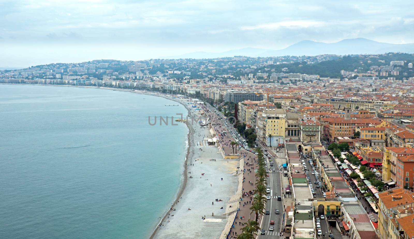 NICE, FRANCE - MAY 5: Promenade des Anglais from above on May 5, 2013 in Nice, France. It is a symbol of the Cote d'Azur and was built in 1830 at the expense of the British colony.

Nice, France - May 05, 2013: Promenade des Anglais from above. Promenade des Anglais is a symbol of the Cote d'Azur and was built in 1830 at the expense of the British colony. People are walking along promenade.