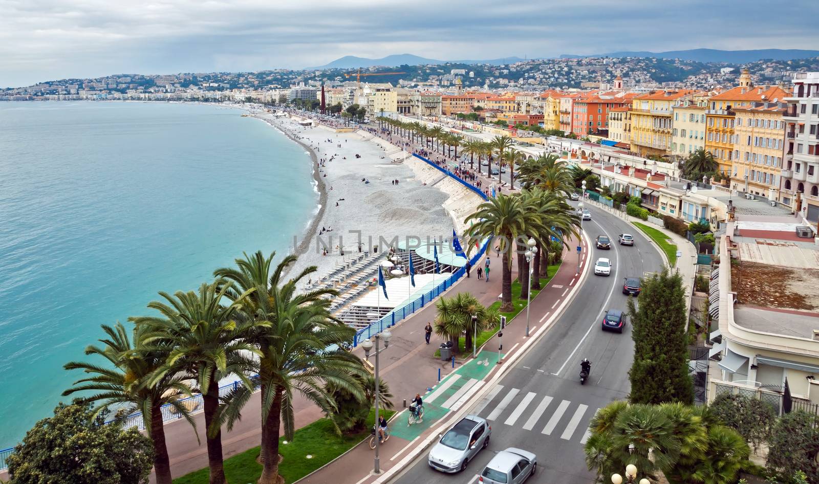 NICE, FRANCE - MAY 5: Promenade des Anglais from above on May 5, 2013 in Nice, France. It is a symbol of the Cote d'Azur and was built in 1830 at the expense of the British colony.

Nice, France - May 05, 2013: Promenade des Anglais from above. Promenade des Anglais is a symbol of the Cote d'Azur and was built in 1830 at the expense of the British colony. People are walking along promenade.