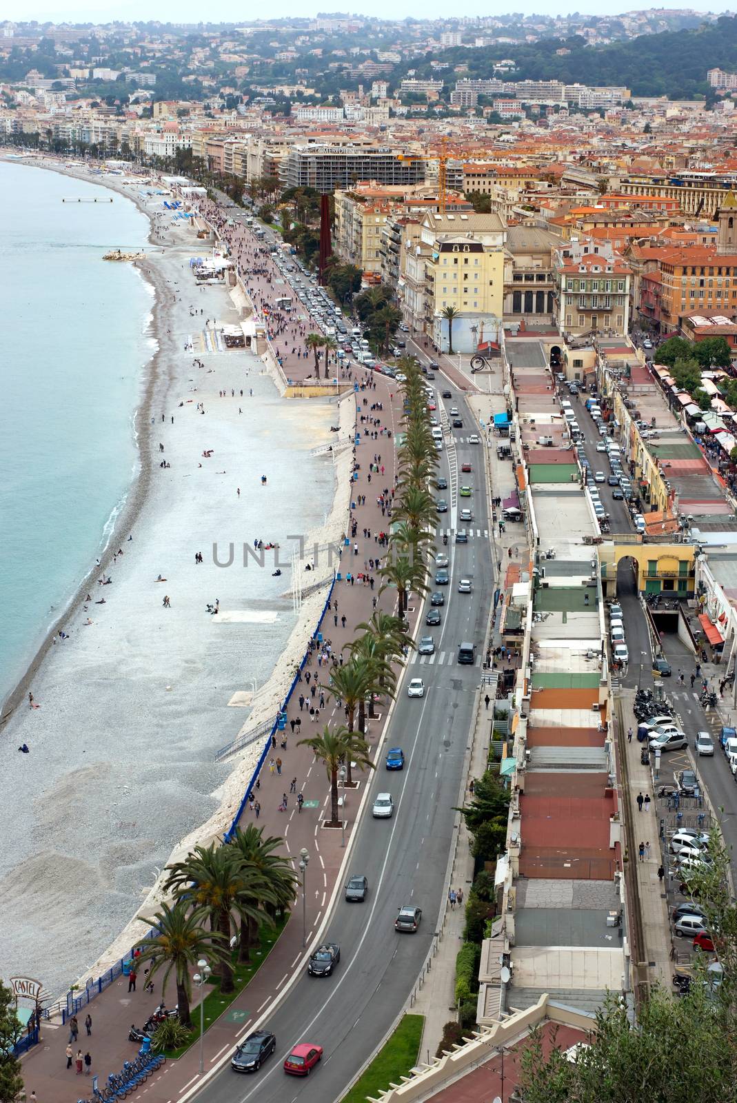 NICE, FRANCE - MAY 5: Promenade des Anglais from above on May 5, 2013 in Nice, France. It is a symbol of the Cote d'Azur and was built in 1830 at the expense of the British colony.

Nice, France - May 05, 2013: Promenade des Anglais from above. Promenade des Anglais is a symbol of the Cote d'Azur and was built in 1830 at the expense of the British colony. People are walking along promenade.