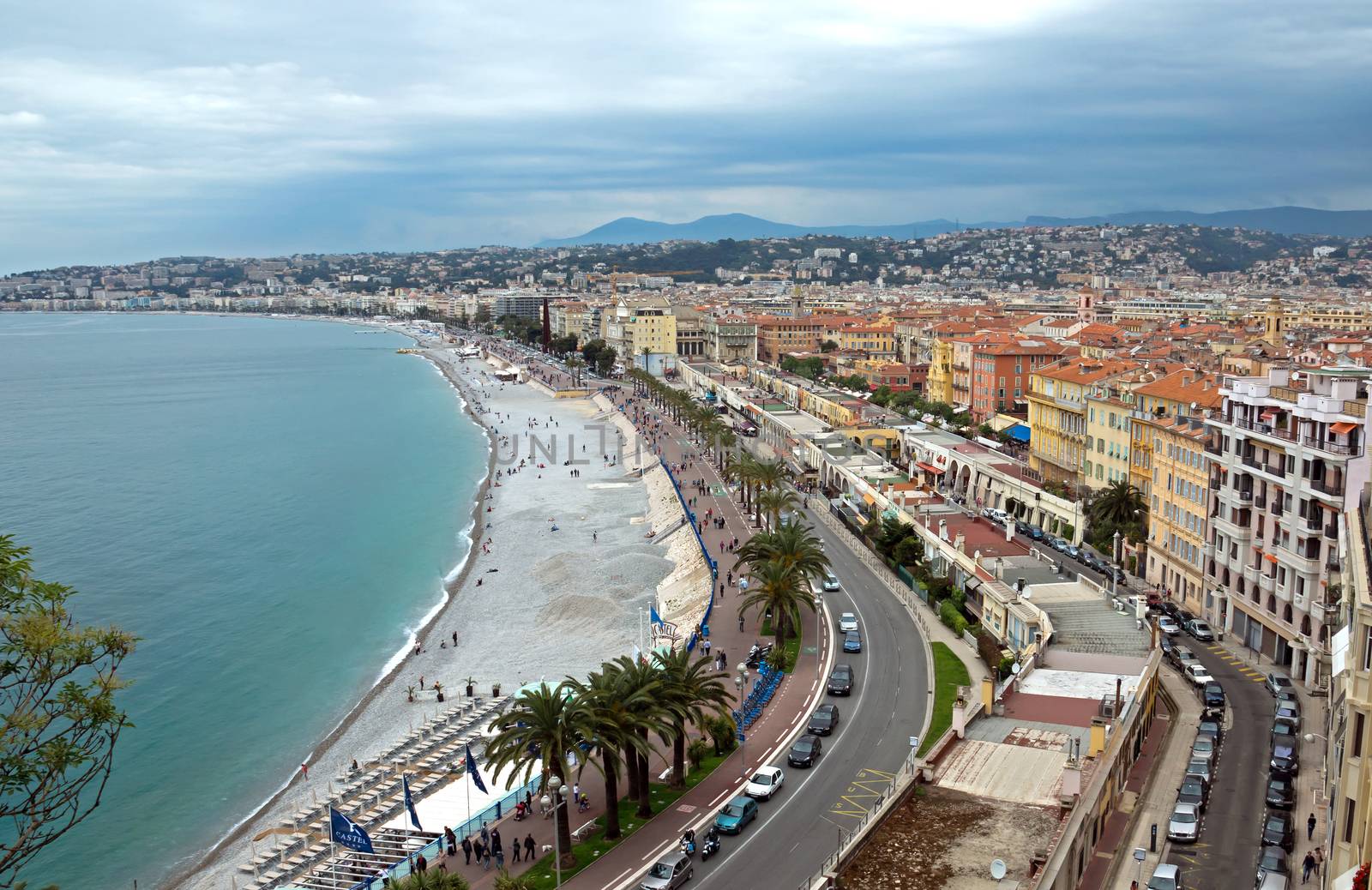 NICE, FRANCE - MAY 5: Promenade des Anglais from above on May 5, 2013 in Nice, France. It is a symbol of the Cote d'Azur and was built in 1830 at the expense of the British colony.

Nice, France - May 05, 2013: Promenade des Anglais from above. Promenade des Anglais is a symbol of the Cote d'Azur and was built in 1830 at the expense of the British colony. People are walking along promenade.