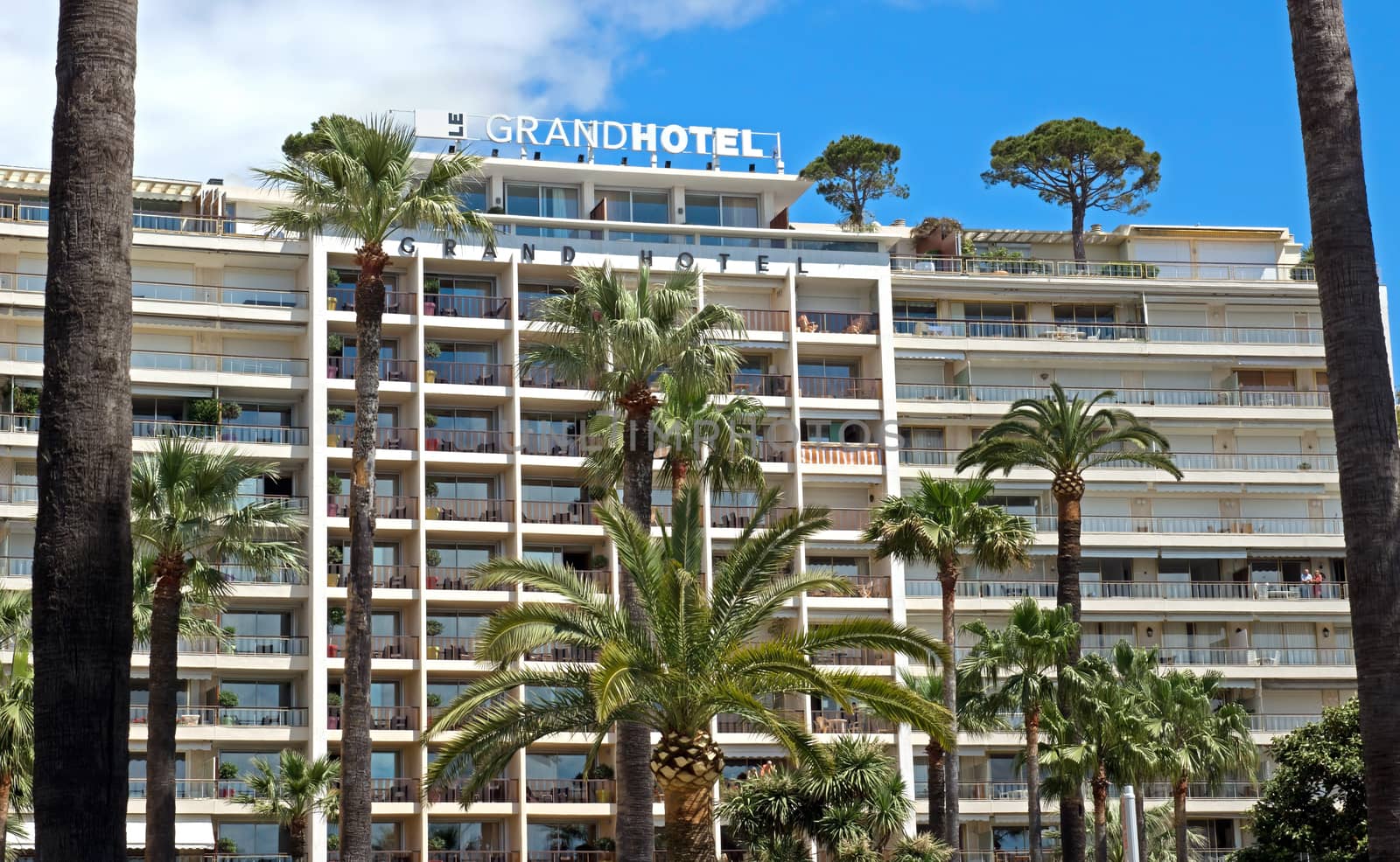 CANNES, FRANCE - MAY 6: Architecture of Cannes along the Croisette on May 6, 2013 in Cannes, France. City founded by the Romans in 42 BC.

Cannes, France - May 6, 2013: Architecture of Cannes along the Croisette. Cannes is a city located in the French Riviera. The city is also famous for its luxury shops, restaurants, and hotels. City founded by the Romans in 42 BC.