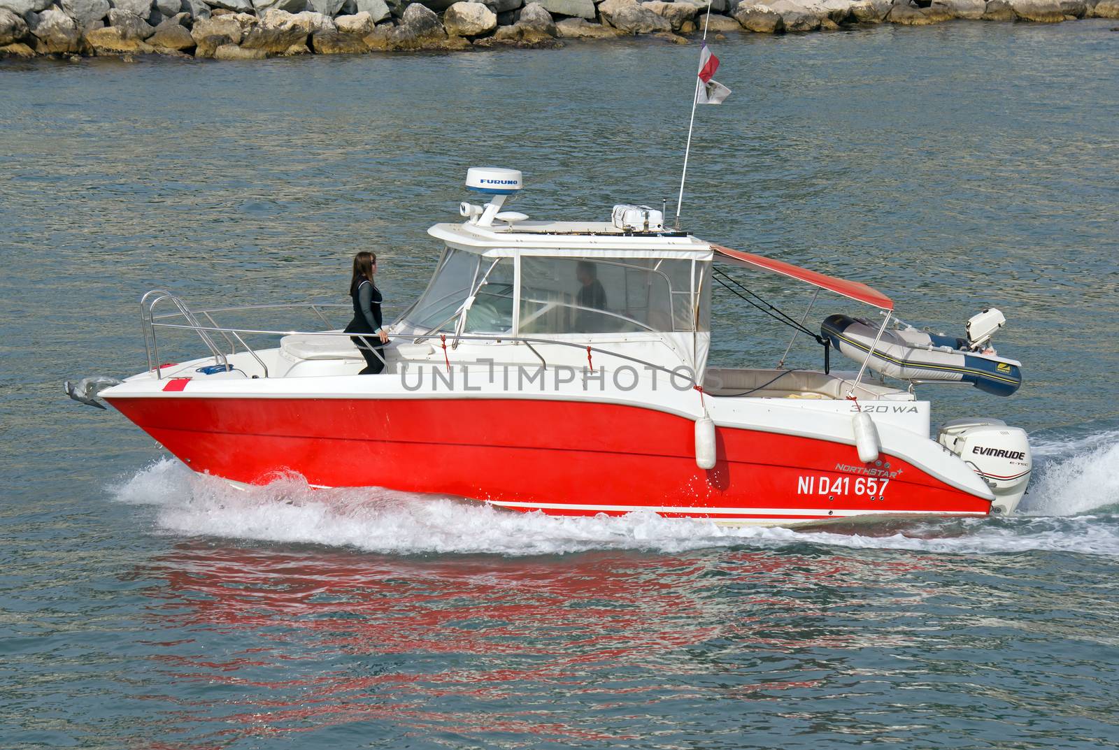 NICE, FRANCE - MAY 4: Escort boat for escorting ships in Port de Nice on May 4, 2013 in Nice, France. An escort boat is compulsory in port for all the cruising ships.

Nice, France - May 4, 2013: Escort boat for escorting ships in Port de Nice. An escort boat is compulsory in port for all the cruising ships. People on boat are escorting the ship arrived to the place of mooring.