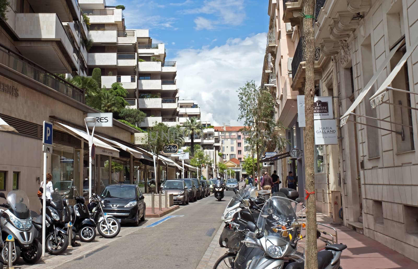 CANNES, FRANCE - MAY 6: Architecture of Cannes along the Croisette on May 6, 2013 in Cannes, France. City founded by the Romans in 42 BC.

Cannes, France - May 6, 2013: Architecture of Cannes along the Croisette. Cannes is a city located in the French Riviera. The city is also famous for its luxury shops, restaurants, and hotels. City founded by the Romans in 42 BC.