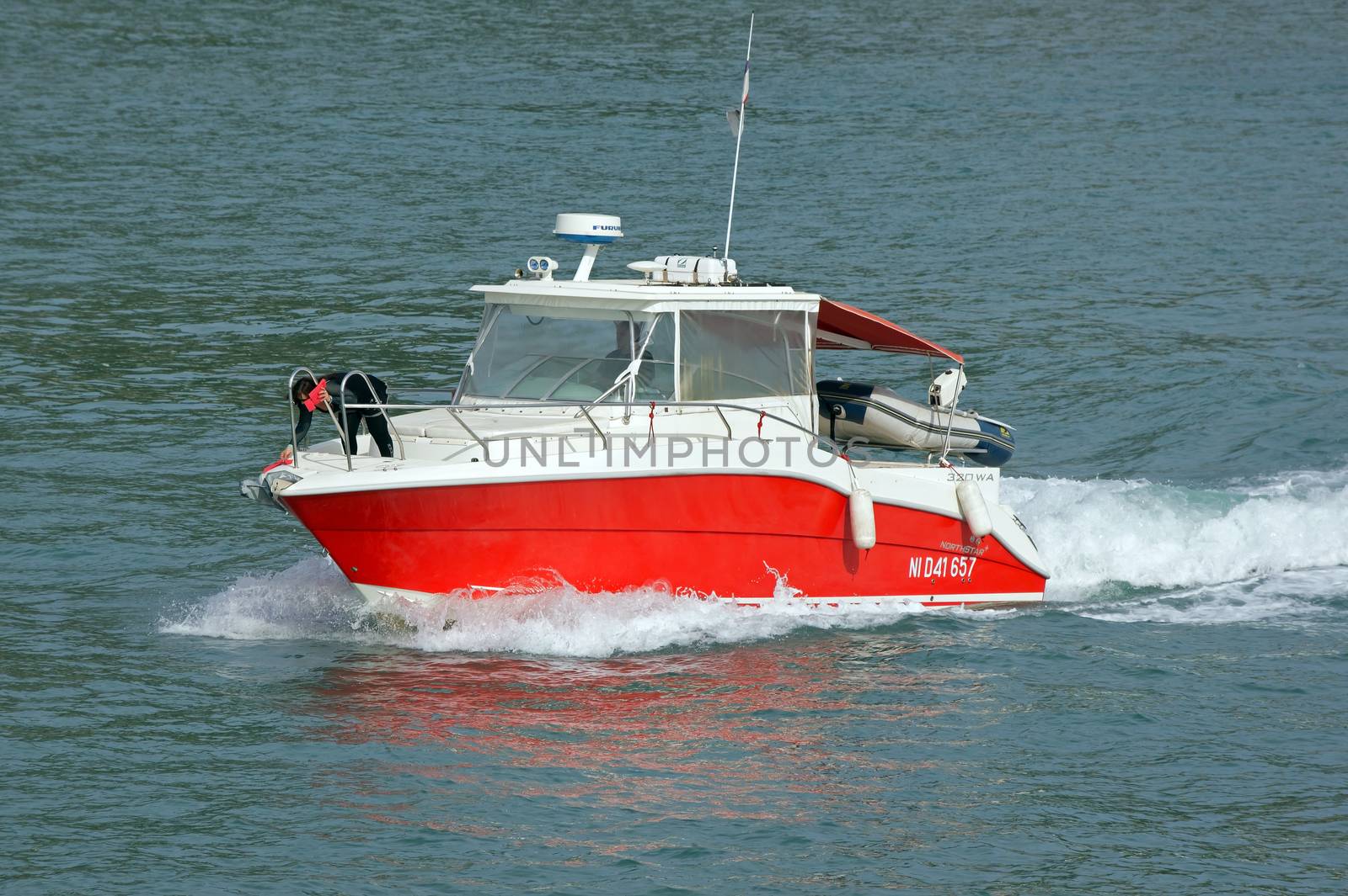NICE, FRANCE - MAY 4: Escort boat for escorting ships in Port de Nice on May 4, 2013 in Nice, France. An escort boat is compulsory in port for all the cruising ships.

Nice, France - May 4, 2013: Escort boat for escorting ships in Port de Nice. An escort boat is compulsory in port for all the cruising ships. People on boat are escorting the ship that arrived to the place of mooring.
