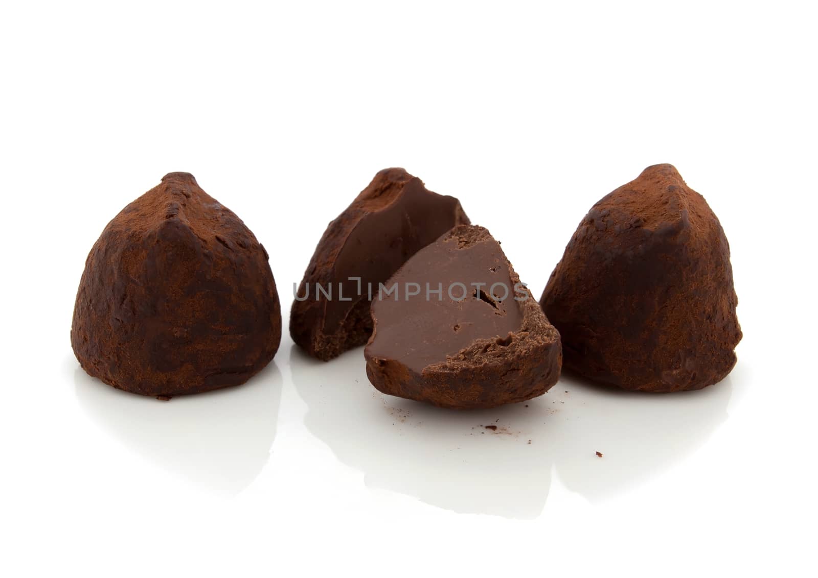 Chocolate truffles on white background.