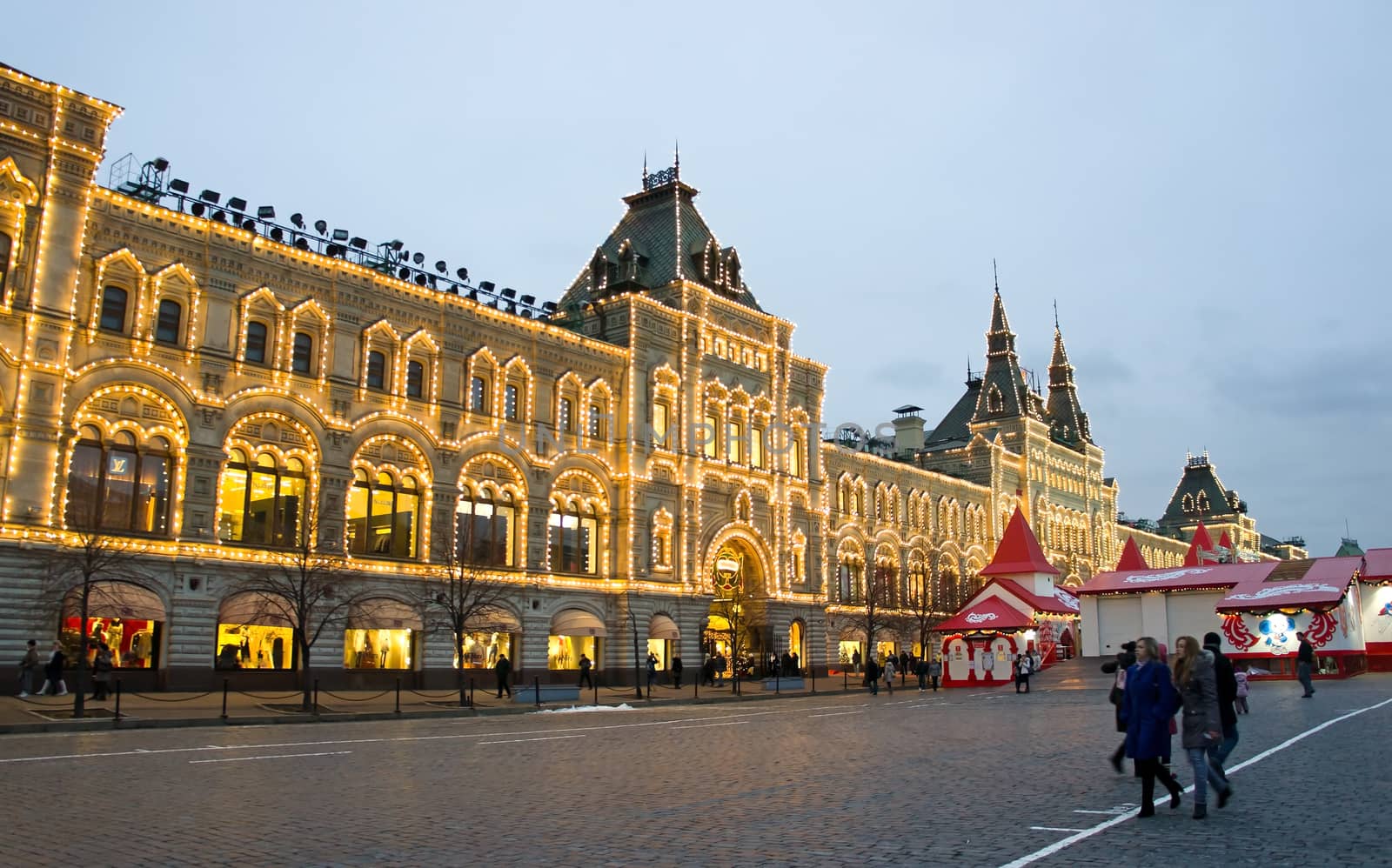 MOSCOW RUSSIA - DECEMBER 29: Exterior view of the  State Department Store in Red Square on December 29, 2011 in Moscow, Russia. It was built between 1890-1893 by Alexander Pomerantsev, there are approximately 200 stores.

Для IS: 
Moscow, Russia - December 29, 2011: Night illumination of the GUM.
GUM department store (Glavnyi Universalnyi Magazin) Moscow on the  Red Square, the Upper Trading Rows were built between 1890 and 1893 by Alexander Pomerantsev.