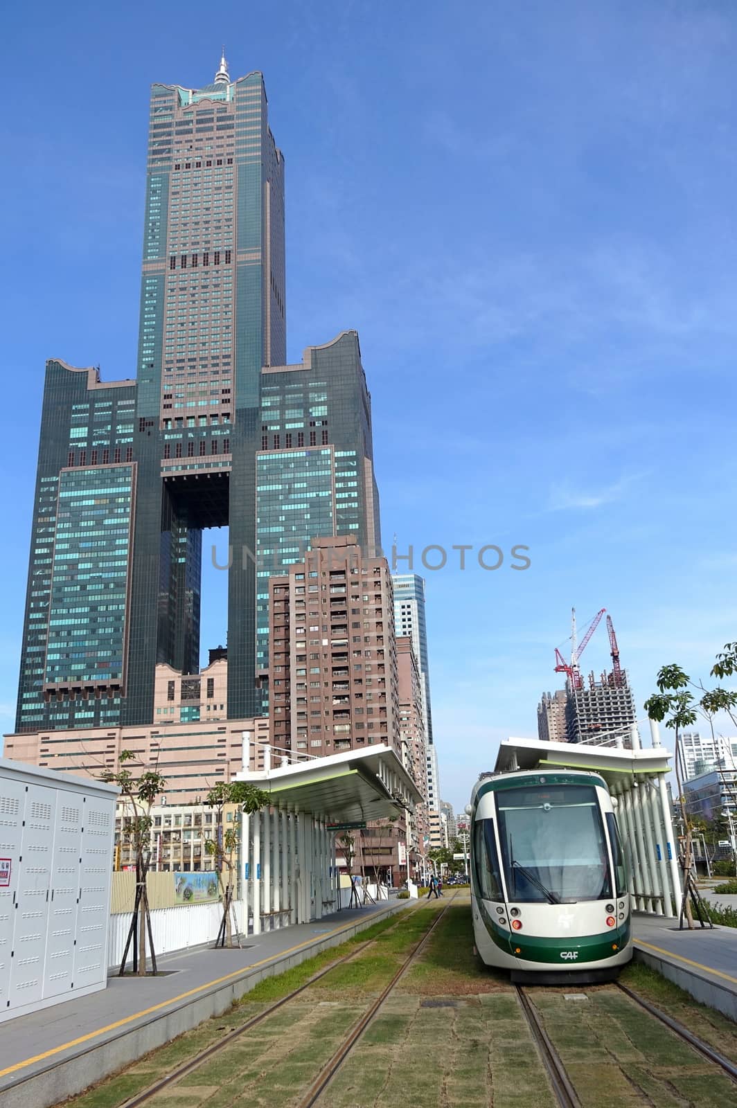KAOHSIUNG, TAIWAN -- JANUARY 29, 2017: The new Kaohsiung light rail tram system, that has recently started partial operations. In the back is the 85 story Tuntex Tower Building.