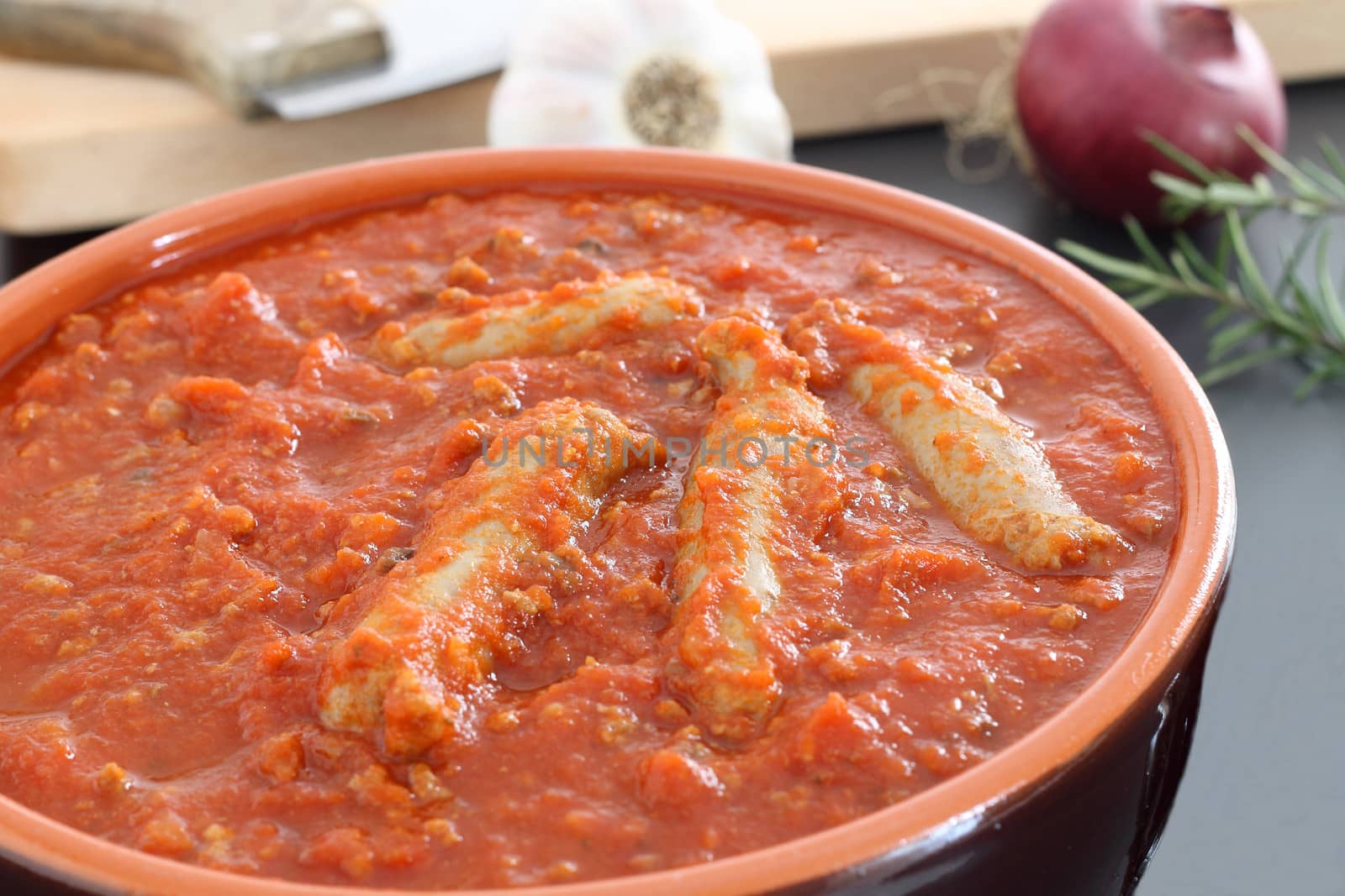 Bolognese sauce with sausage in terracotta pan