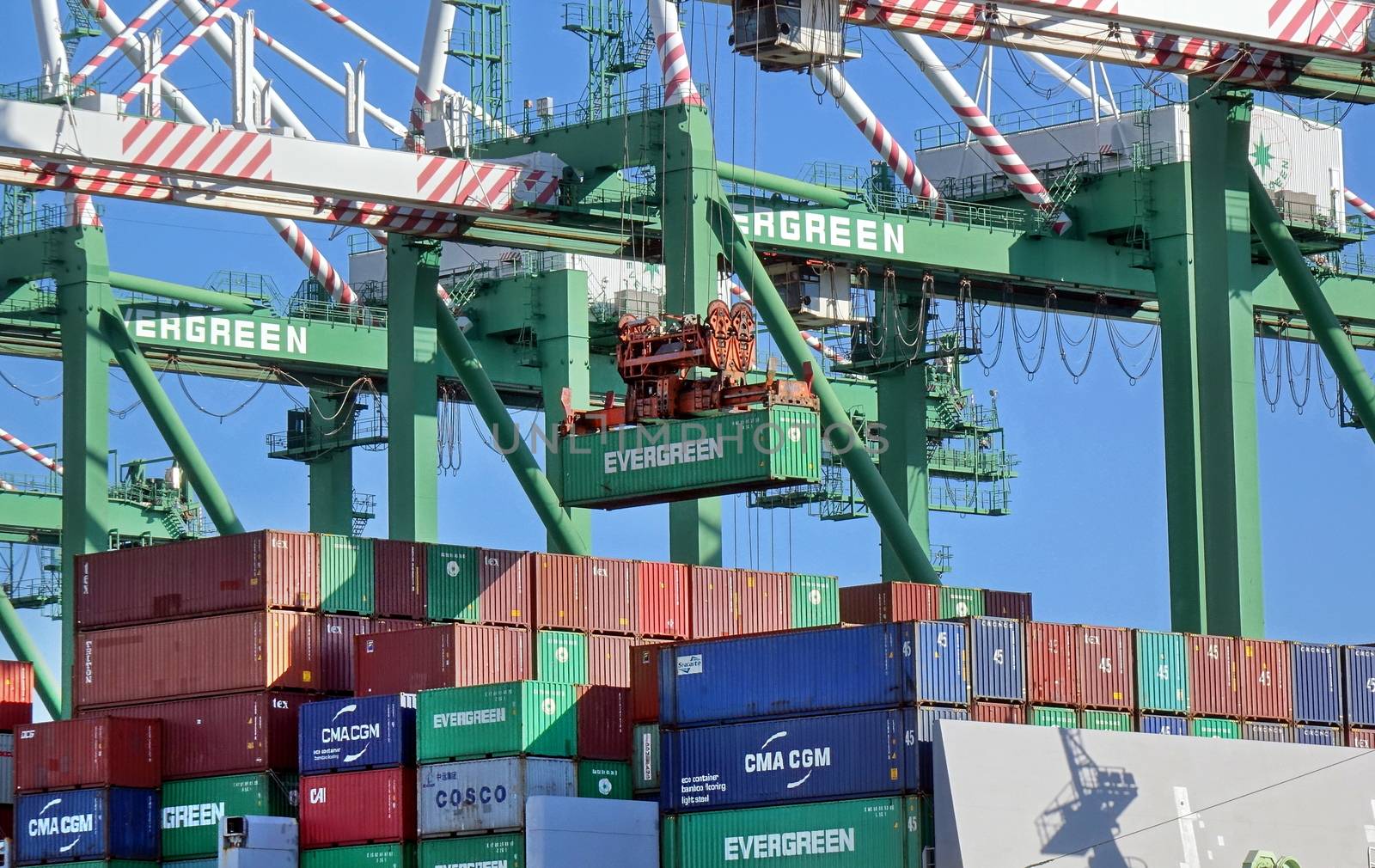 KAOHSIUNG, TAIWAN -- JUNE 2, 2019: Containers are being loaded onto ships in Kaohsiung Port.