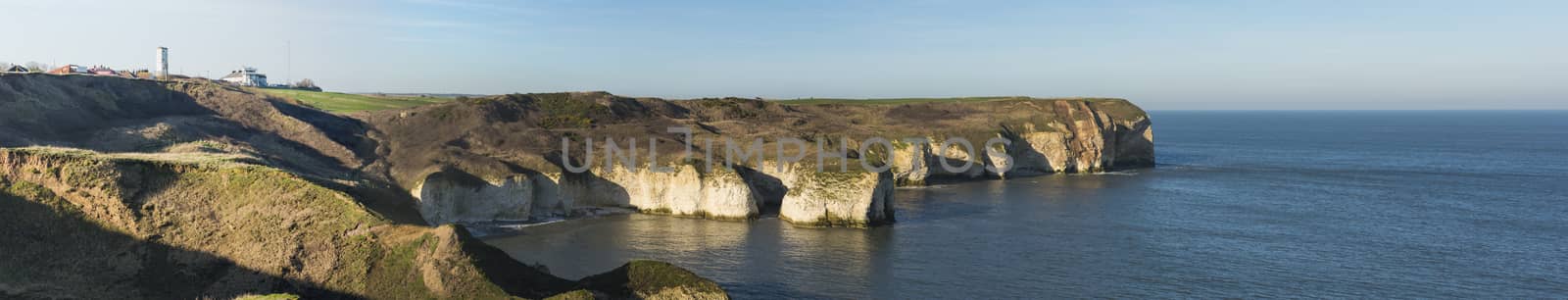 Landscape coastal scene of large chalks cliffs coastline dropping into sea