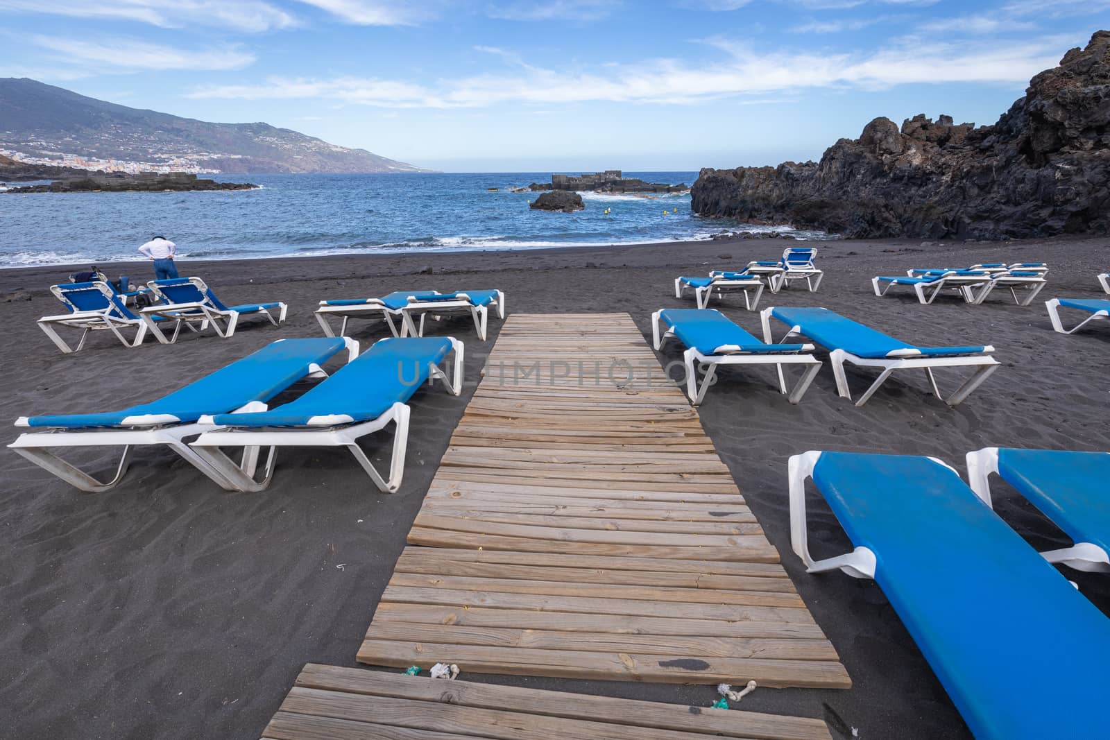 Blue sunbeds and black sand beach at Los Cancajos. La Palma, Can by mariusz_prusaczyk