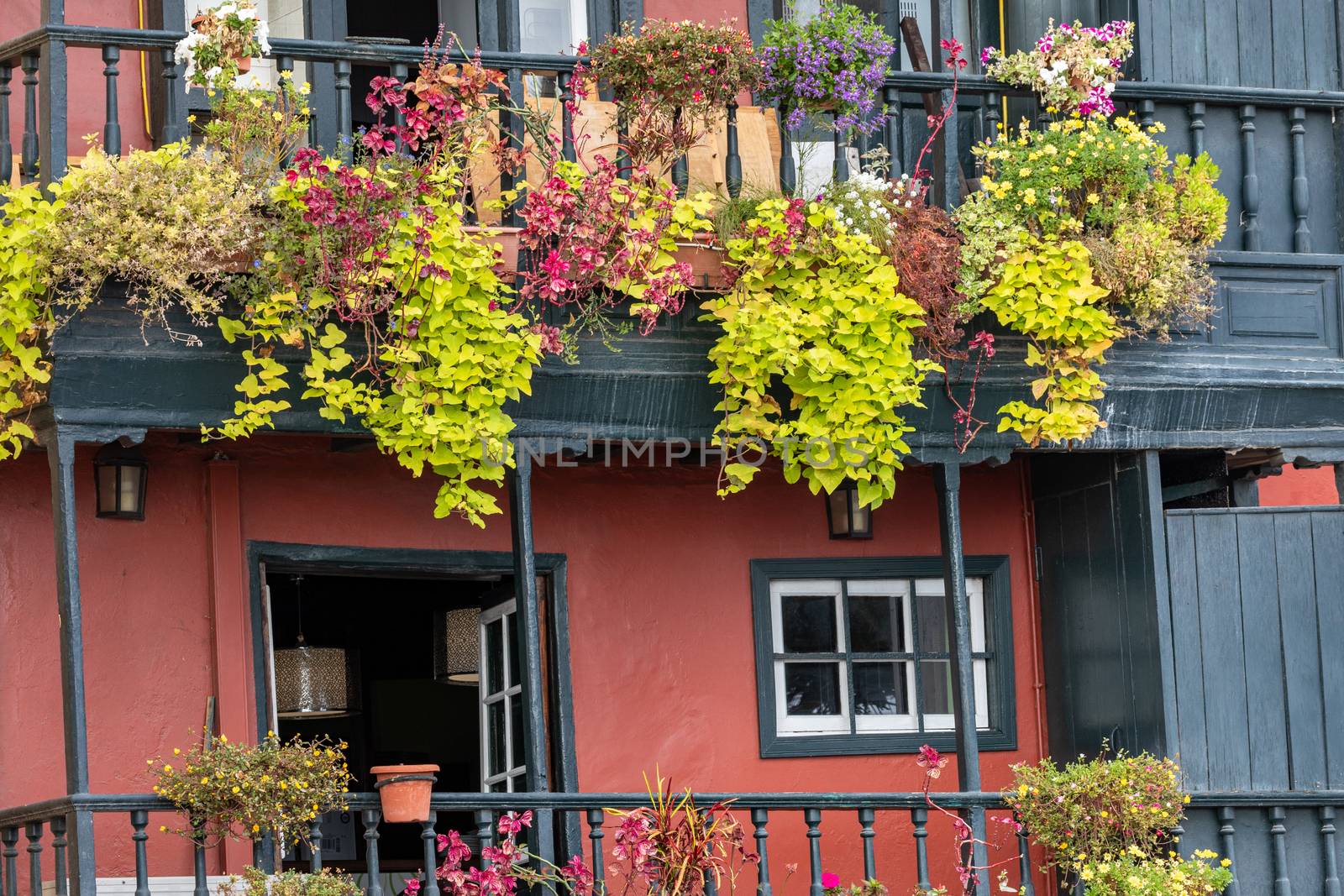 Famous ancient colorful balconies decorated with flowers. Santa Cruz - capital city of the island of La Palma, Canary Islands, Spain.