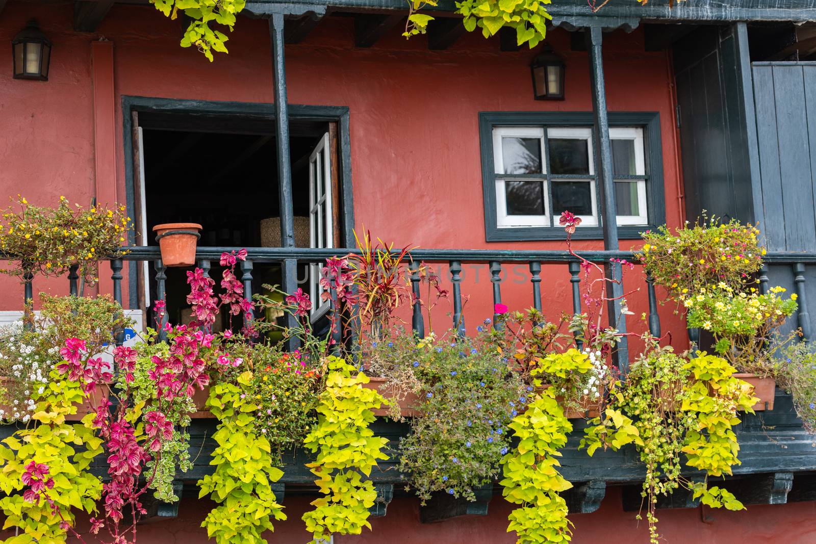 Famous ancient colorful balconies decorated with flowers. Santa Cruz - capital city of the island of La Palma, Canary Islands, Spain.