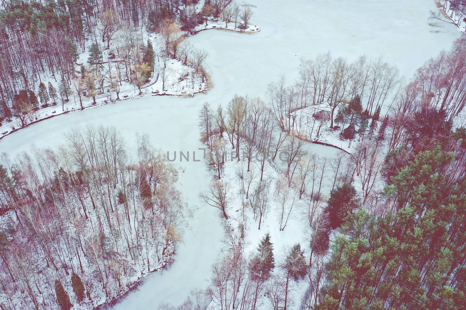 Aerial view of frozen lake. Winter scenery. Landscape photo captured with drone above winter wonderland.