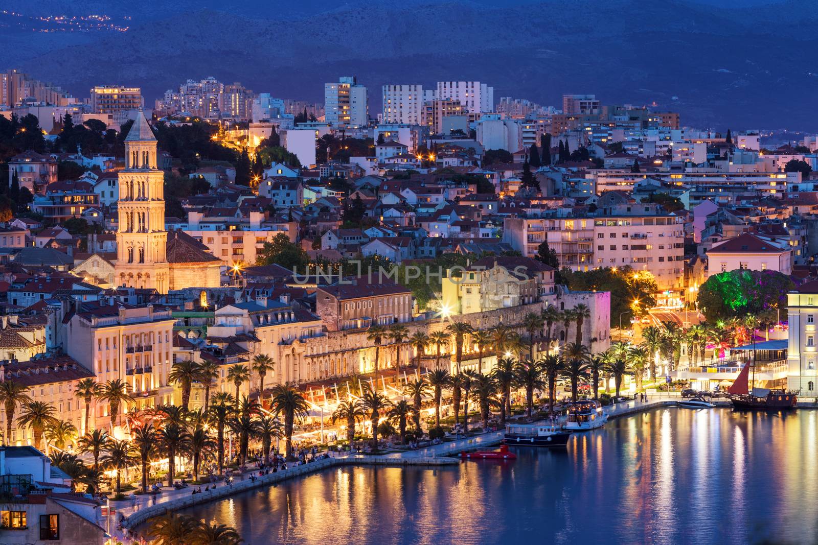 Amazing Split city waterfront panorama at blue hour, Dalmatia, Europe. Roman Palace of the Emperor Diocletian and tower of Saint Domnius cathedral. Split, Croatia. 