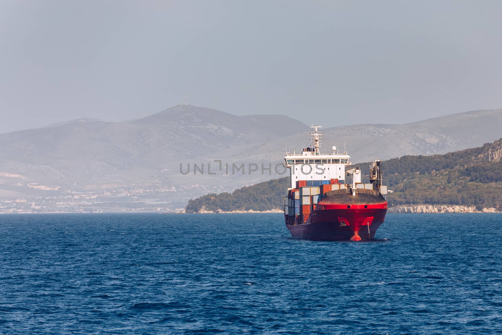 Sailboat in the sea in the evening sunlight with mountains background, luxury summer adventure, active vacation in Mediterranean sea, Croatia. Sailing ship luxury yacht with white sails in the Sea. 