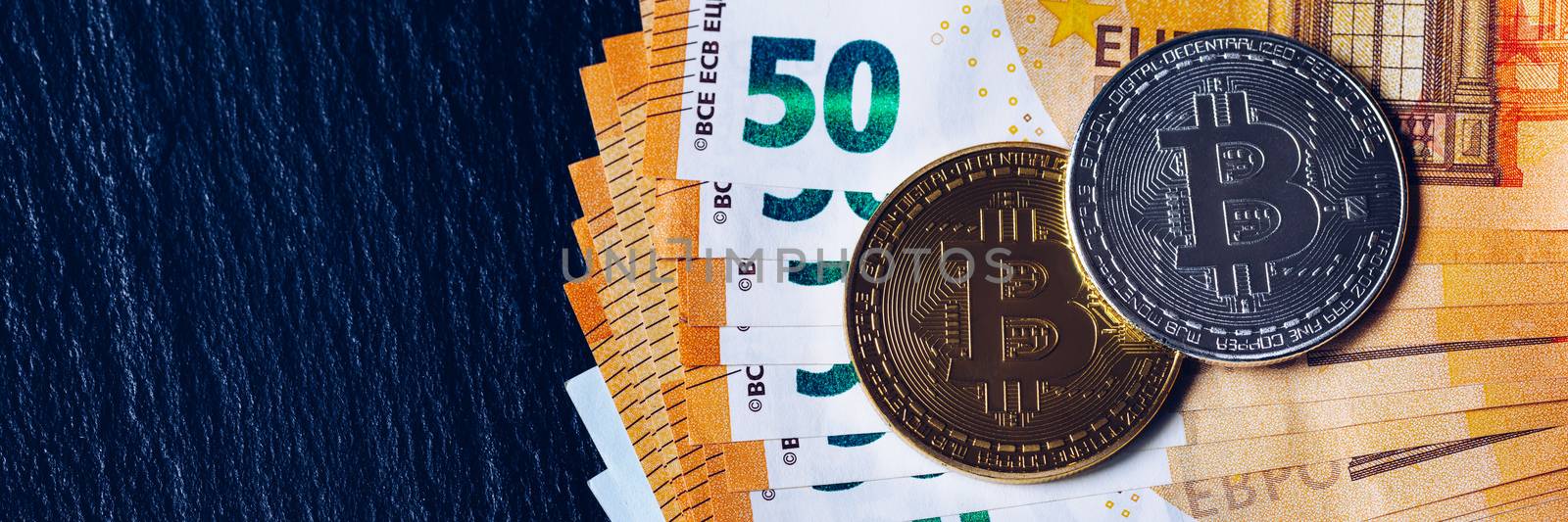 Golden bitcoin over Euro money. Bitcoin cryptocurrency. Crypto currency concept. Bitcoin with euro bills. Bitcoins stacked on euro banknotes.