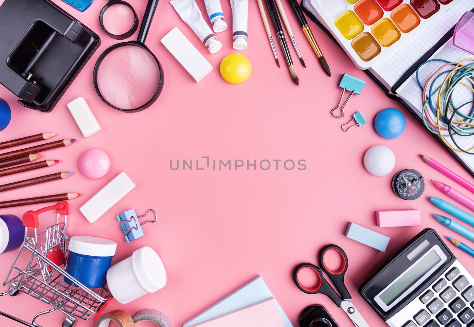 Back to school concept. School and office supplies on pink table. Flat lay with copy space.