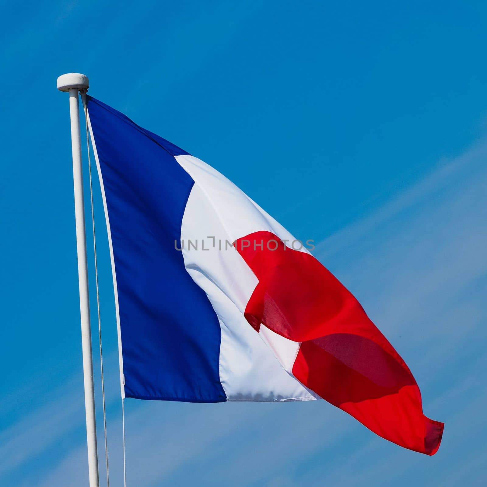 the French national flag of France, Europe over blue sky