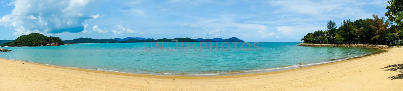 Panoramic shot of a beautiful golden sand beach with blue water  by Shalinimathur