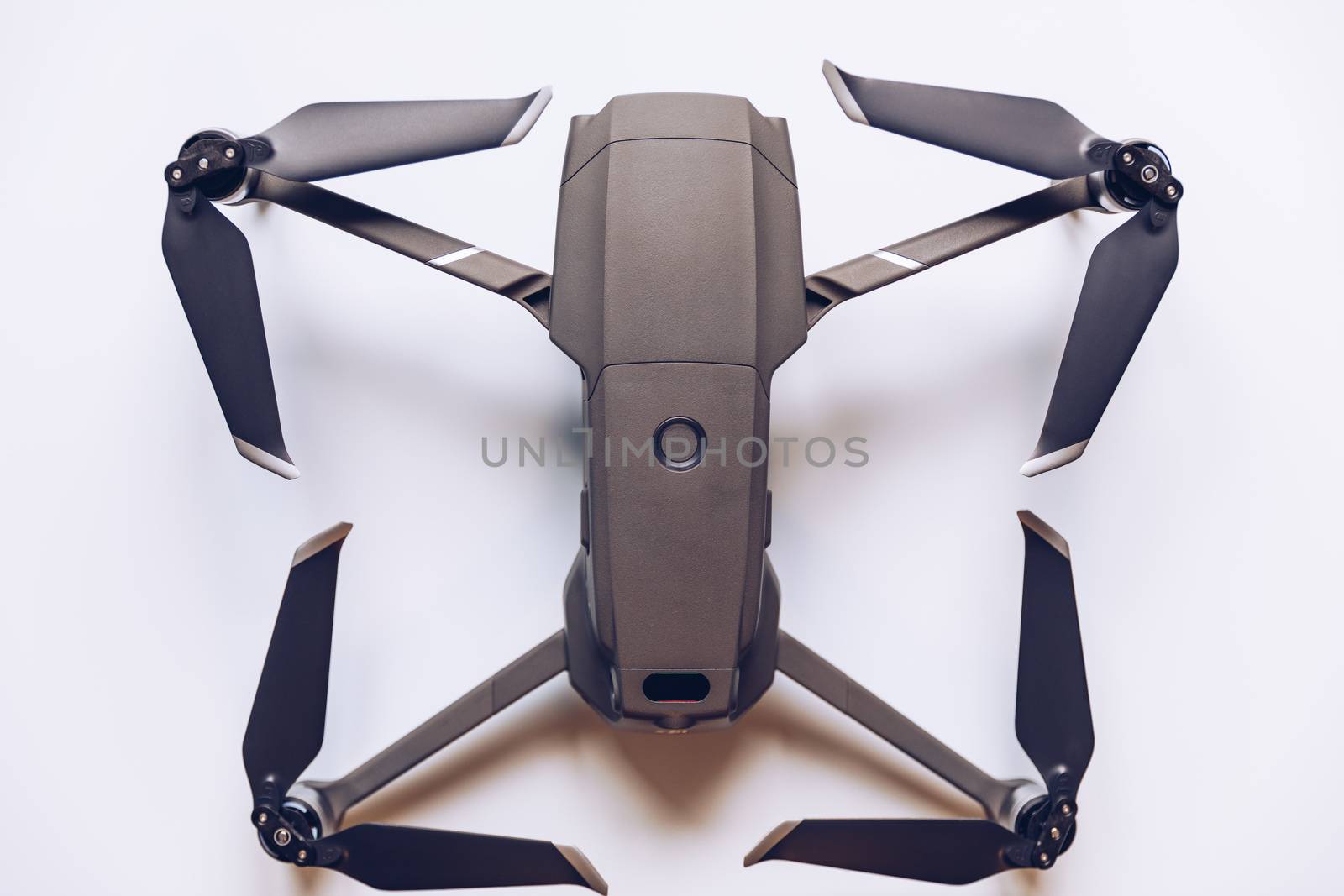 New modern drone on display on white background. Drone quadcopter with digital camera.