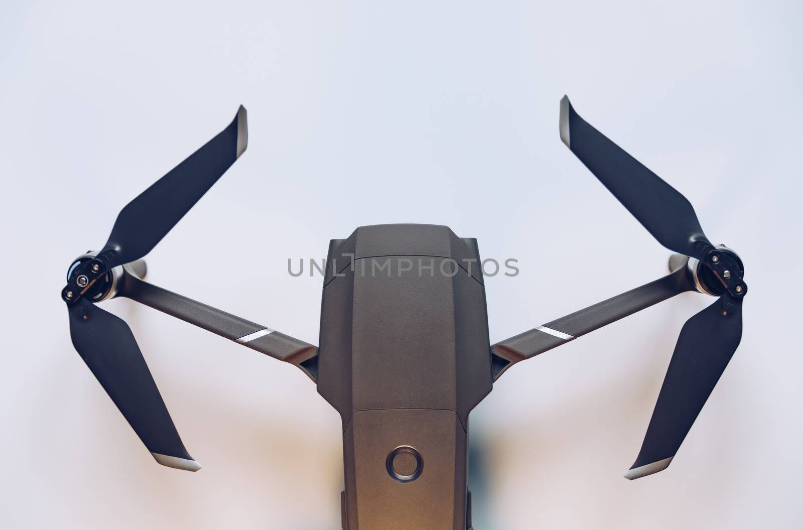 New modern drone on display on white background. Drone quadcopter with digital camera.