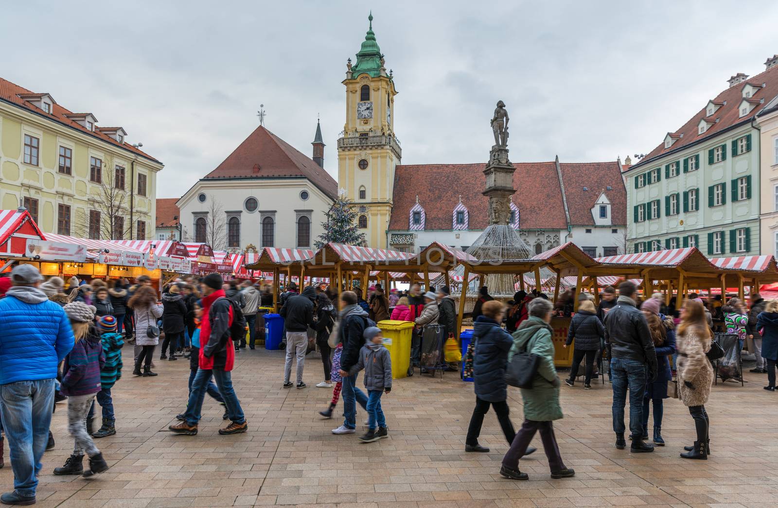 View on Christmas market on the Main square in Bratislava,Slovakia. Stara radnica and Bratislava Christmas Market, blurred people can be seen.