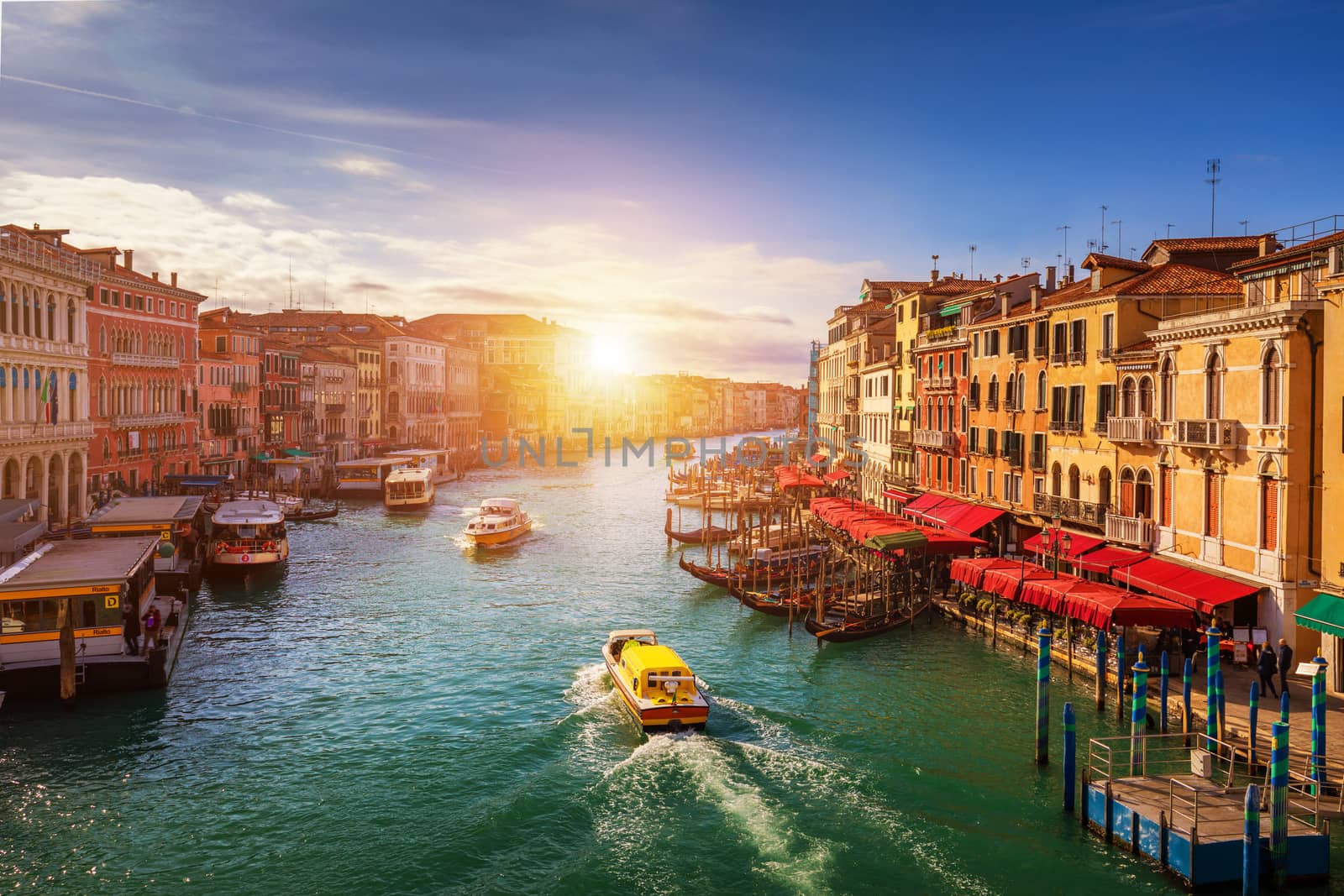 Grand Canal with gondolas in Venice, Italy. Sunset view of Venice Grand Canal. Architecture and landmarks of Venice. Venice postcard