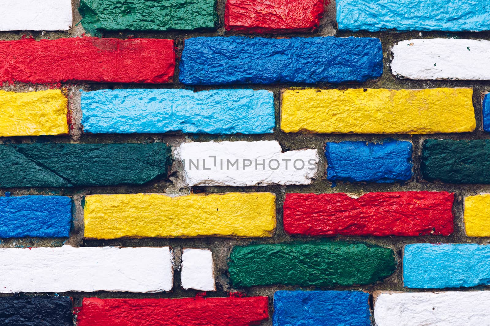 Burano, Venice, Italy. Brightly painted exterior brick wall in the colors of the rainbow. Burano village is famous for its colorful houses which are visible to the fishermen from the lagoon in mist. Venice, Italy.