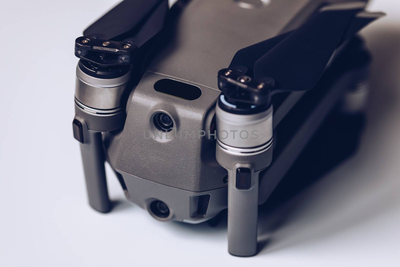 New modern drone on display on white background. Drone quadcopter with digital camera.