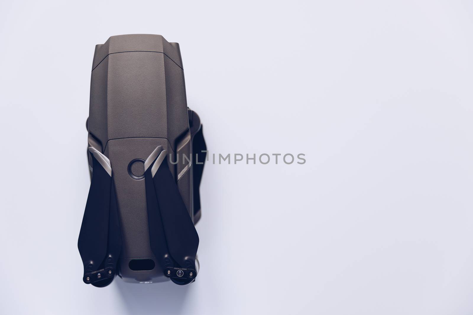 New modern drone on display on white background. Drone quadcopter with digital camera.