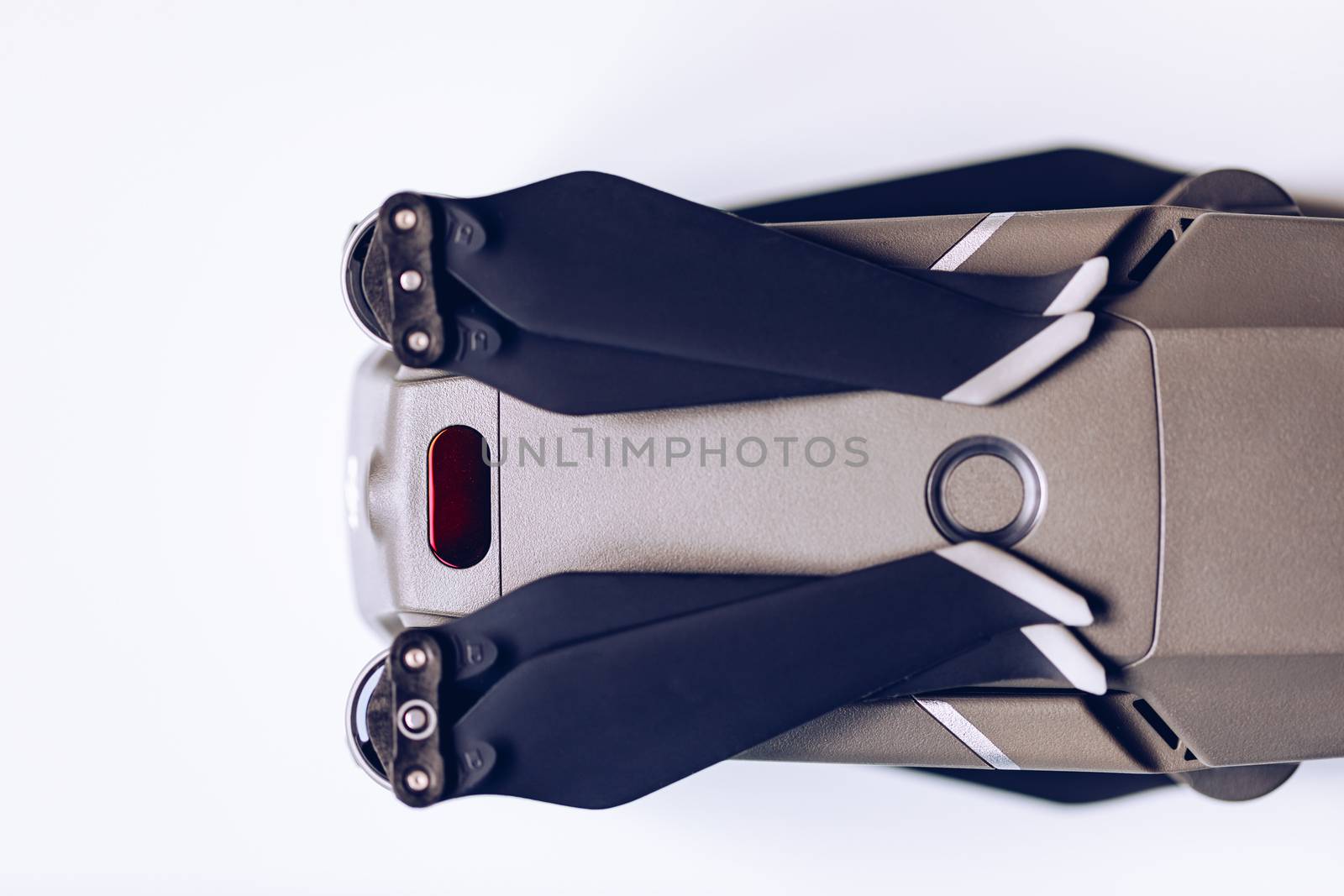 New modern drone on display on white background. Drone quadcopter with digital camera.