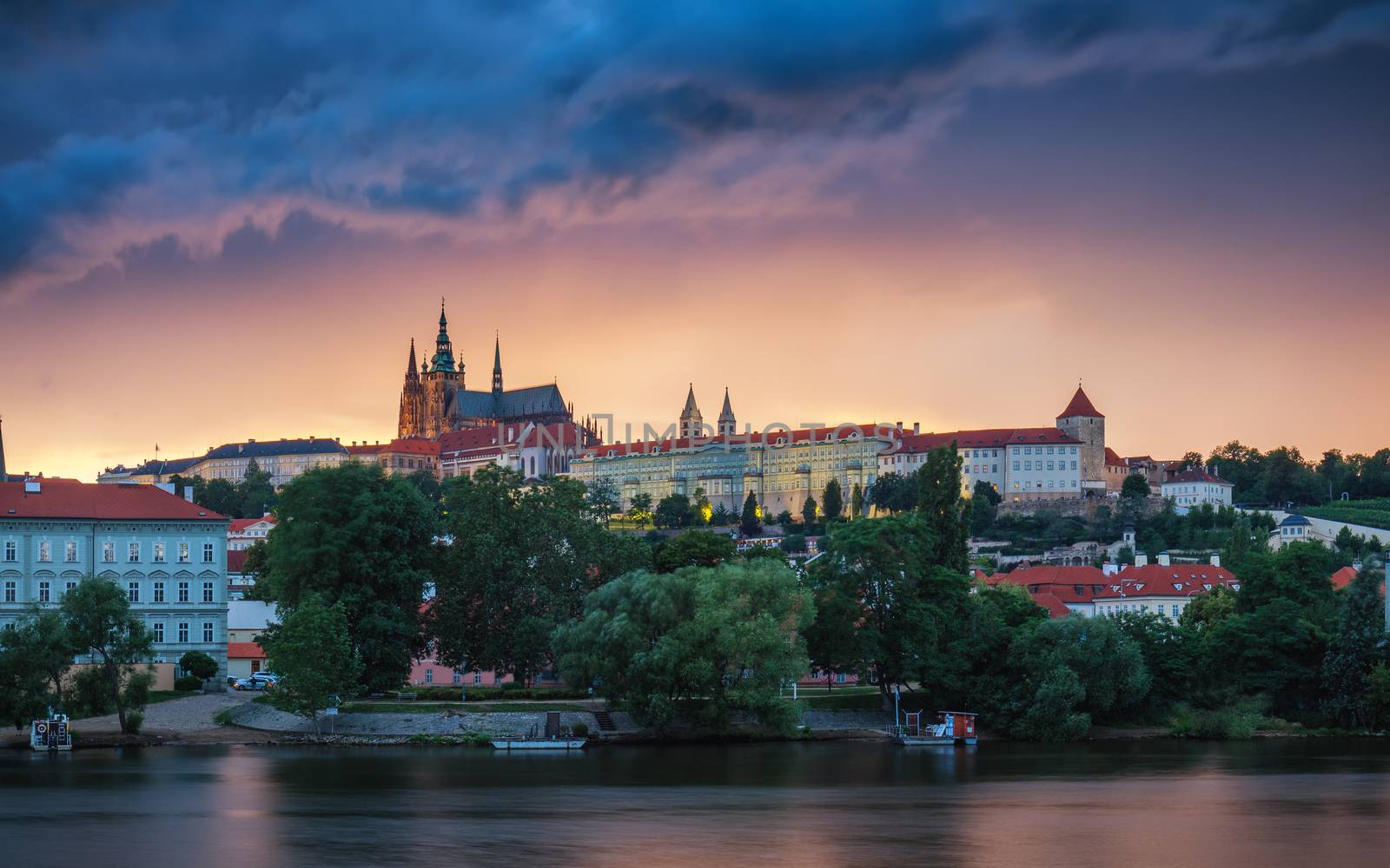 Prague old town including Prague castle in the background, one of the most famous landmarks of Prague at sunset with dramatic sky.