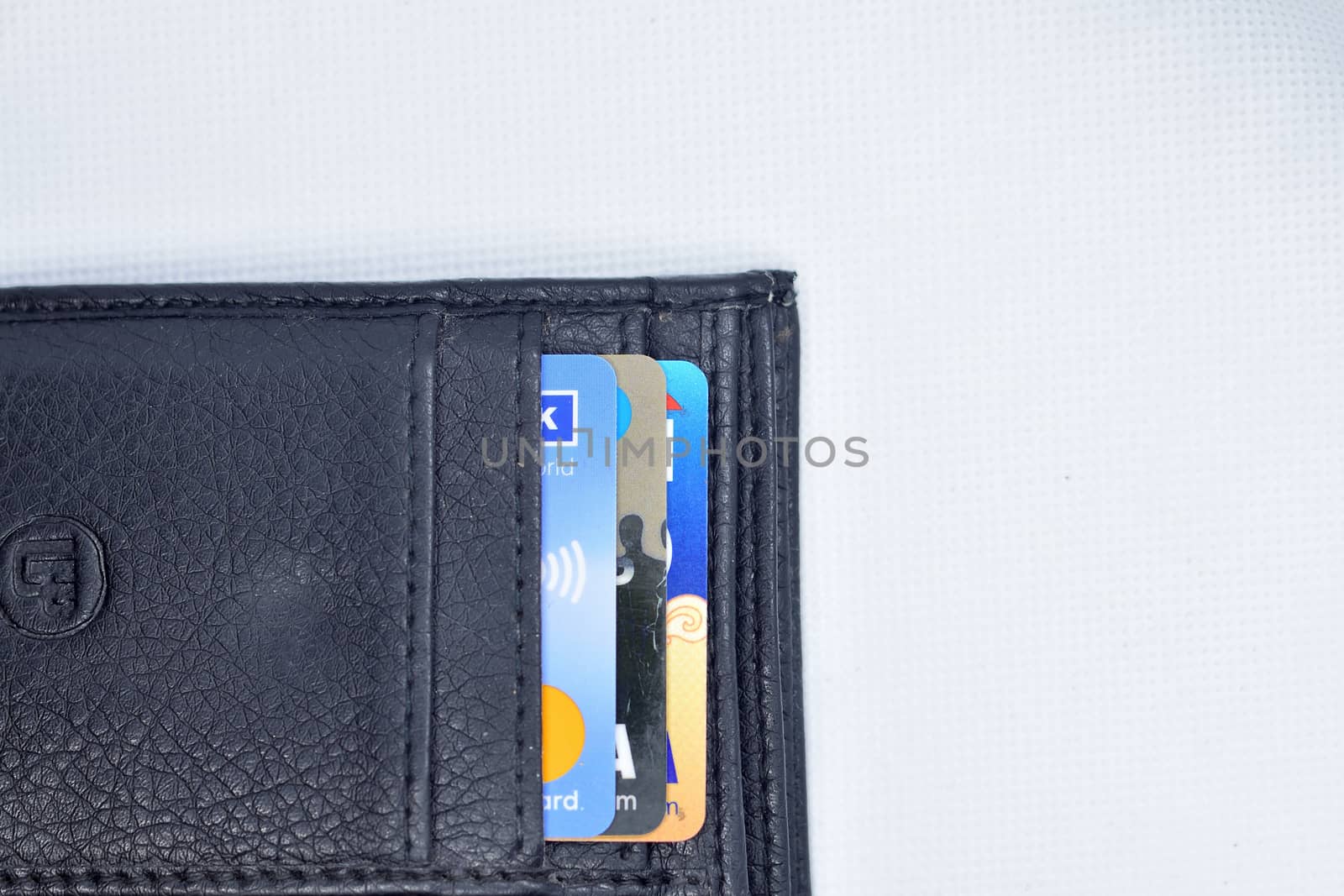Debit and Credit cards in black color wallet on white background. Top view. by rkbalaji