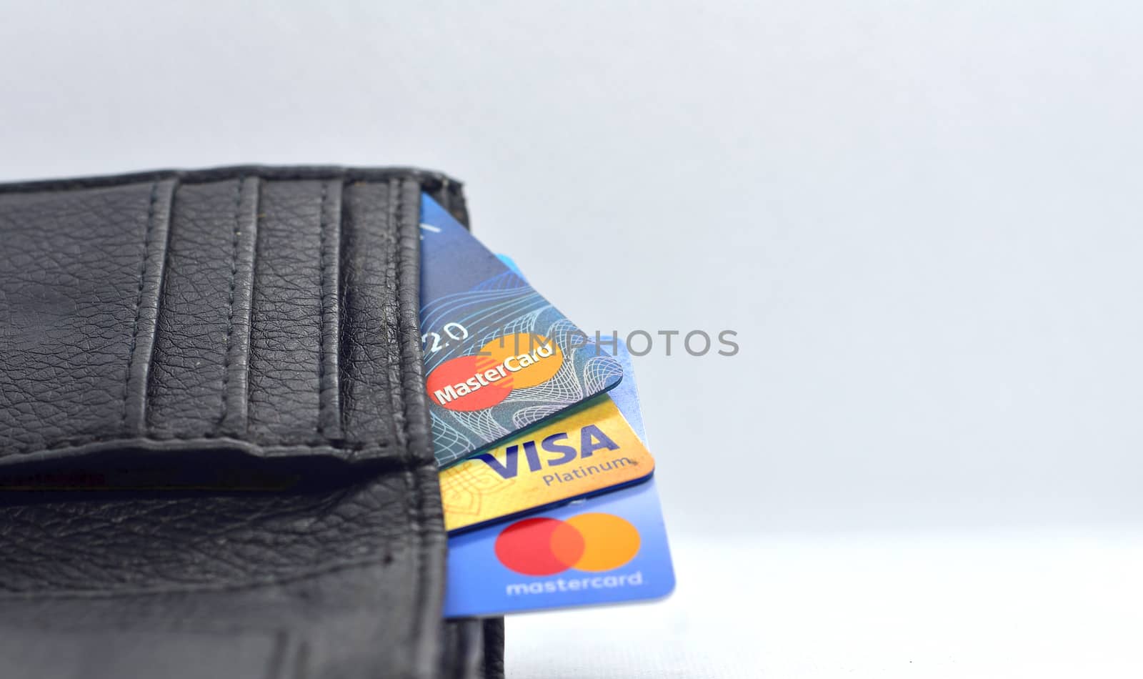 Debit and Credit cards in wallet on white background. side view