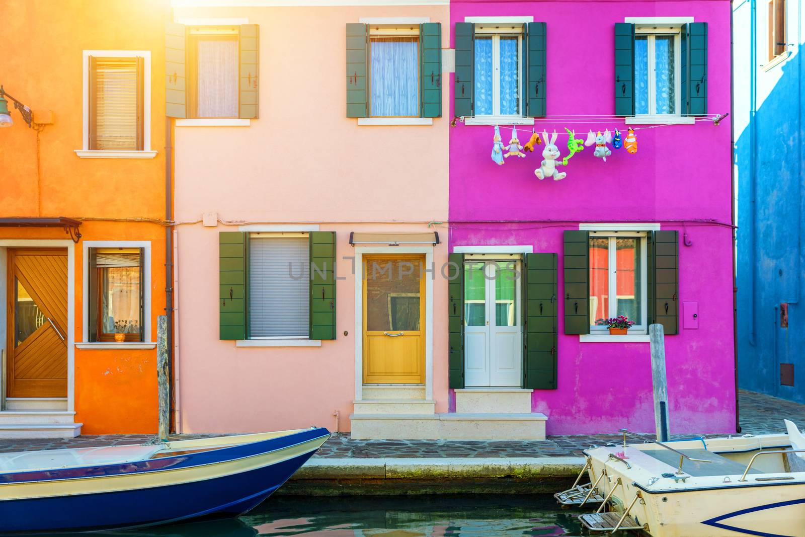 Lovely house facade and colorful walls in Burano, Venice. Burano island canal, colorful houses and boats, Venice landmark, Italy. Europe