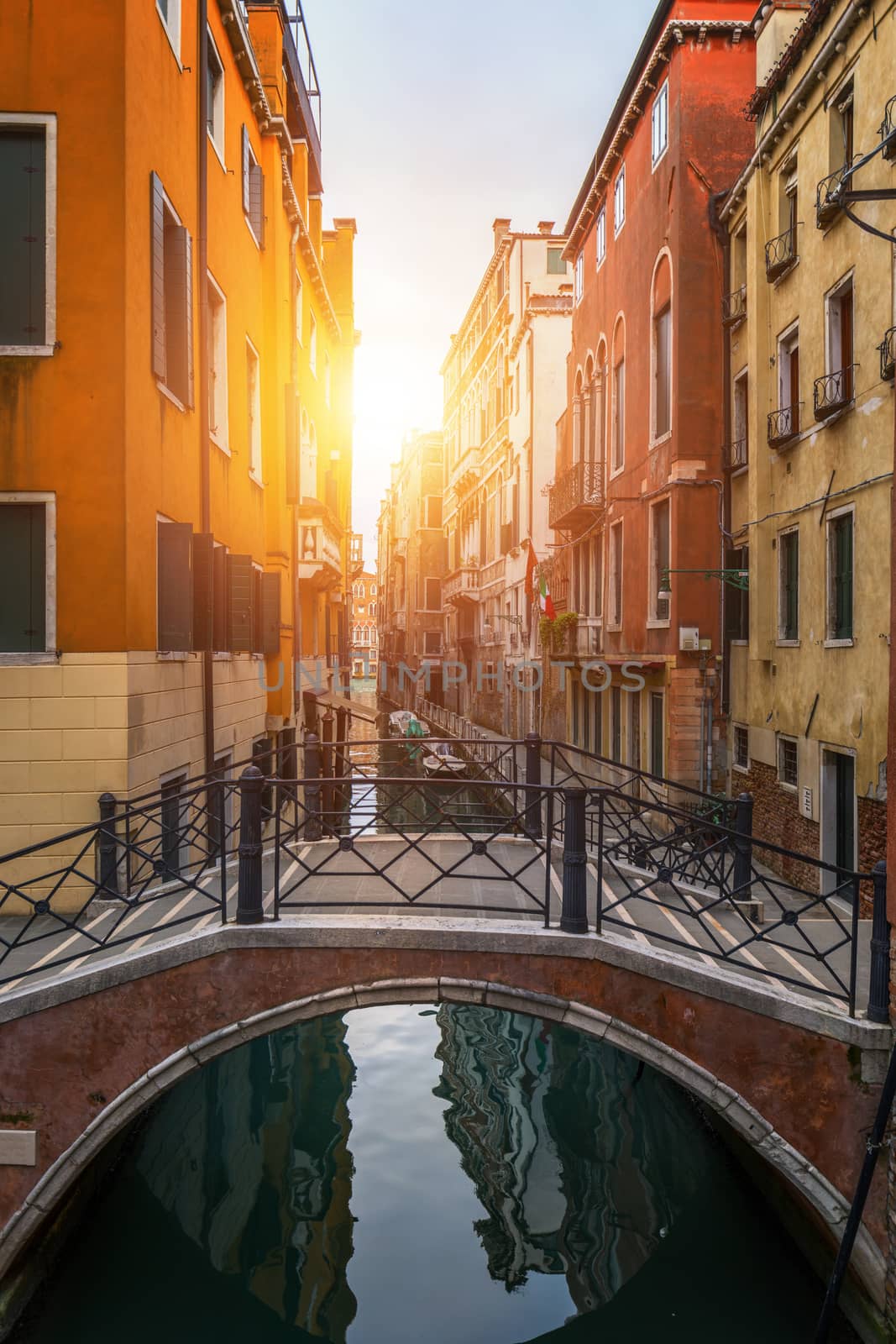 View of the street canal in Venice, Italy. Colorful facades of old Venice houses. Venice is a popular tourist destination of Europe. Venice, Italy.