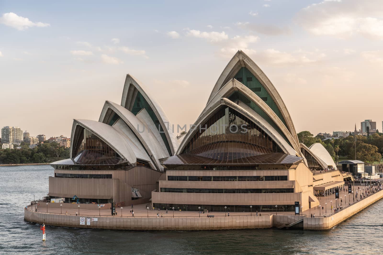 Sydney, Australia - February 12, 2019: Closeup of North side of the Opera House. Light Blue sky and gray water. Horizon is South shore of bay.