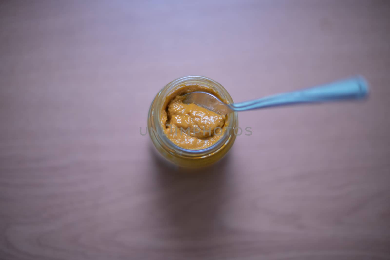 Selective focus of mustard jar with spoon by rushay