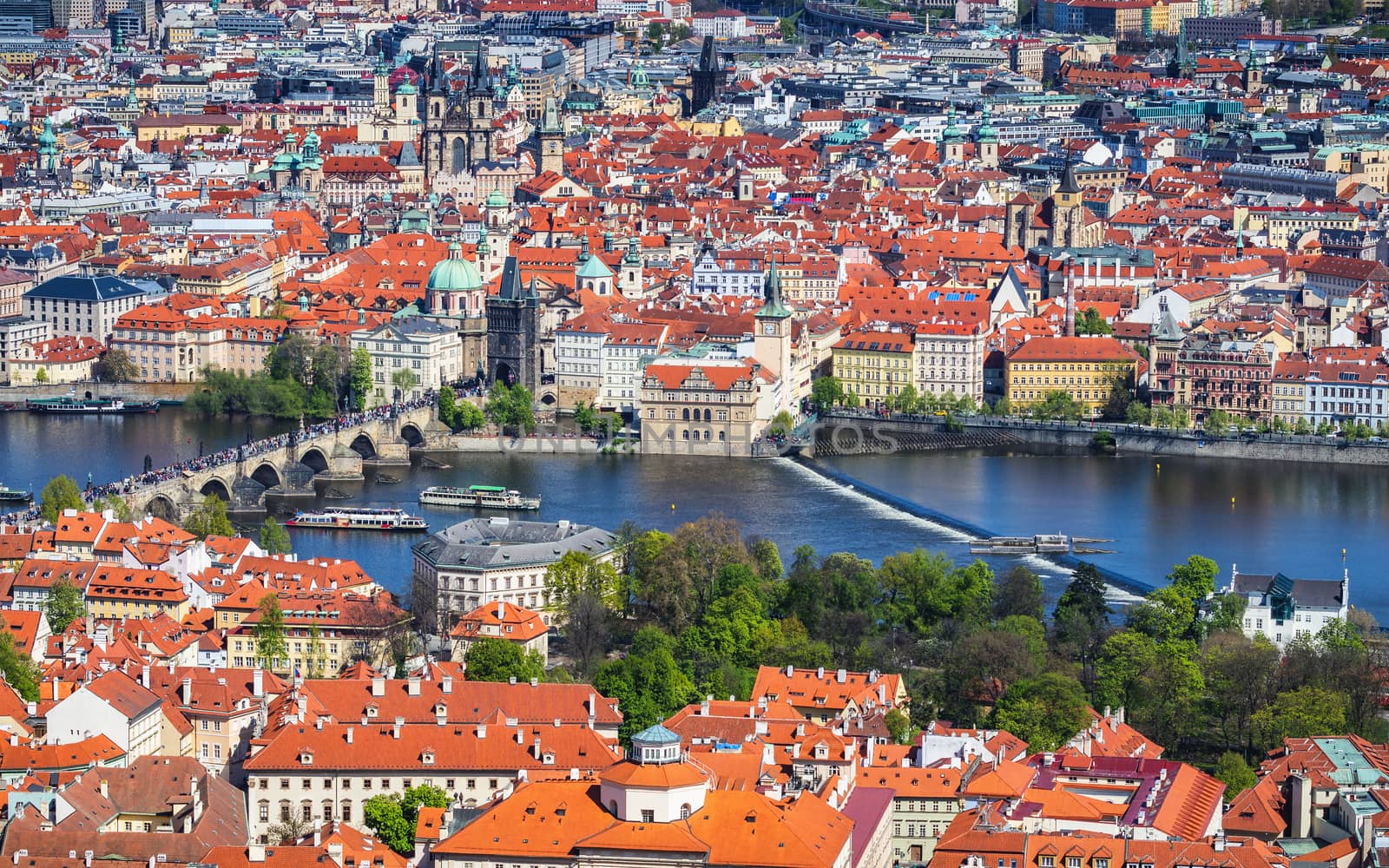 Aerial view of old Red Tiles roofs in the city Prague, Czech Republic, Europe. Beautiful day with blue sky with clouds in the town.