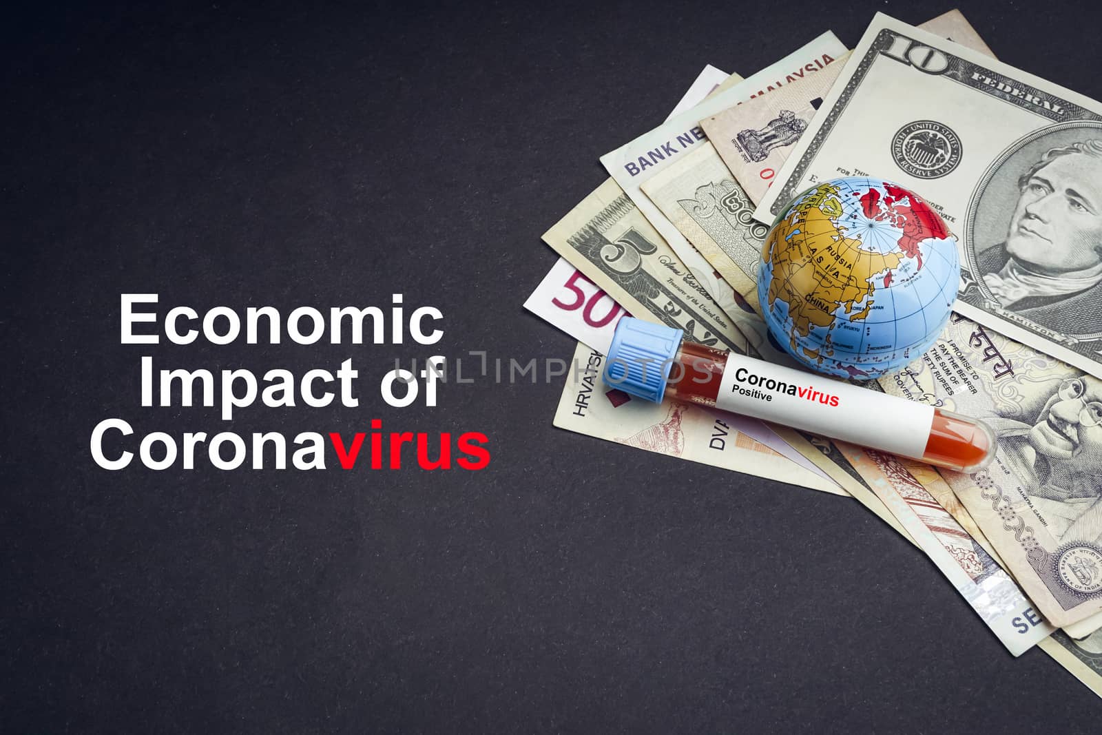 ECONOMIC IMPACT OF CORONAVIRUS text with currency banknotes, world globe and blood test vacuum tube on black background by silverwings